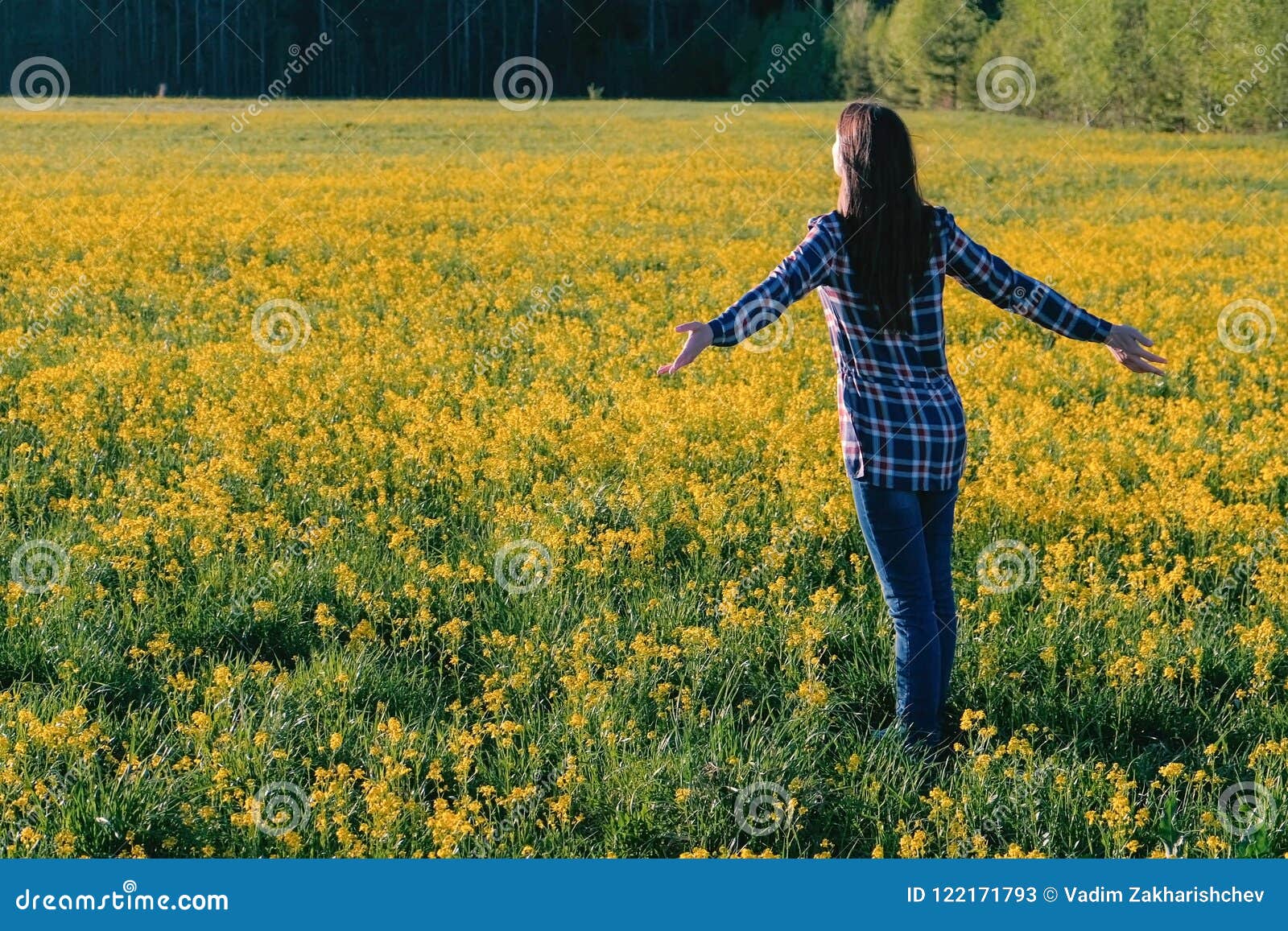 Portrait of Young Woman With Yellow Flowers in Field 