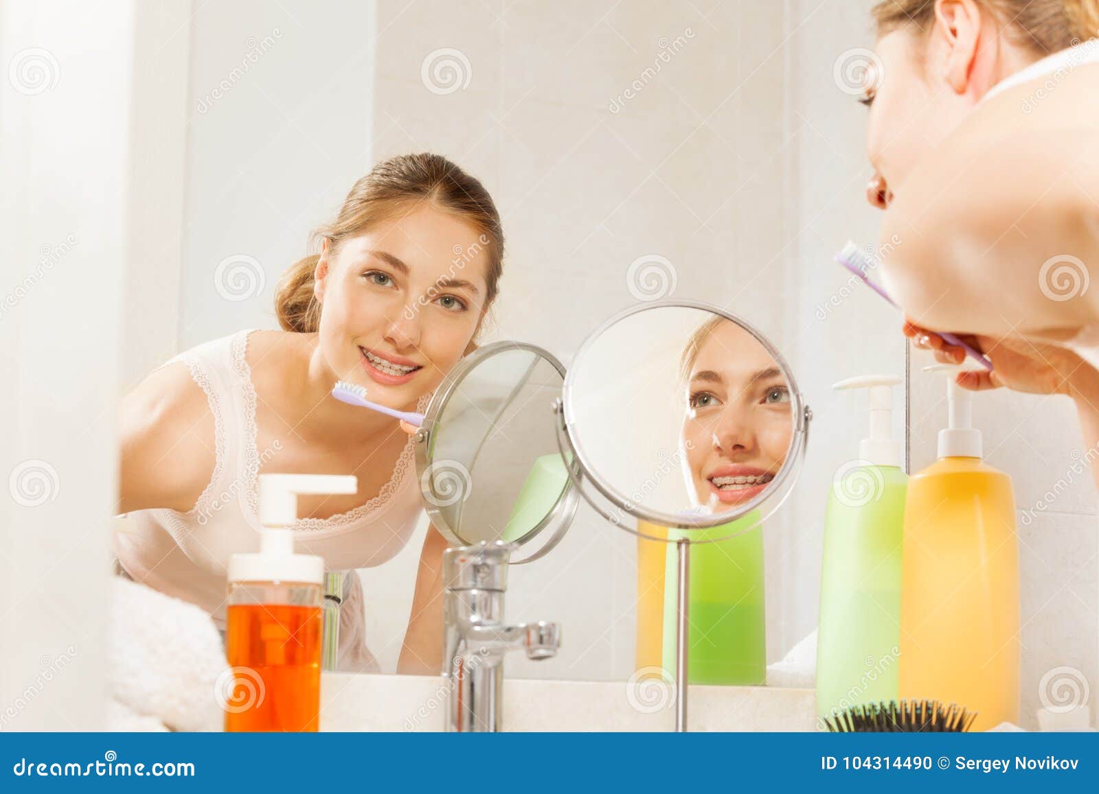 Woman Brushing Her Teeth Seen in Bathroom Mirror Stock Photo Image of