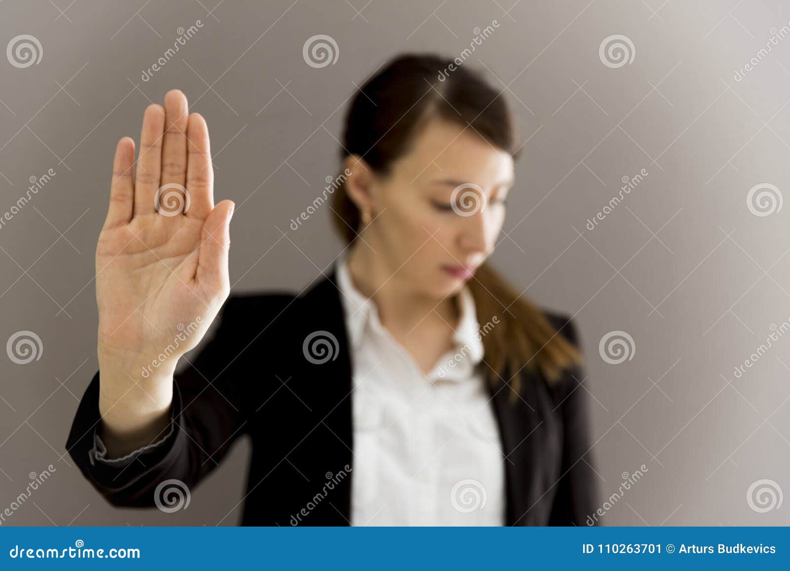 woman in business suit showing her palm, body language, say no a