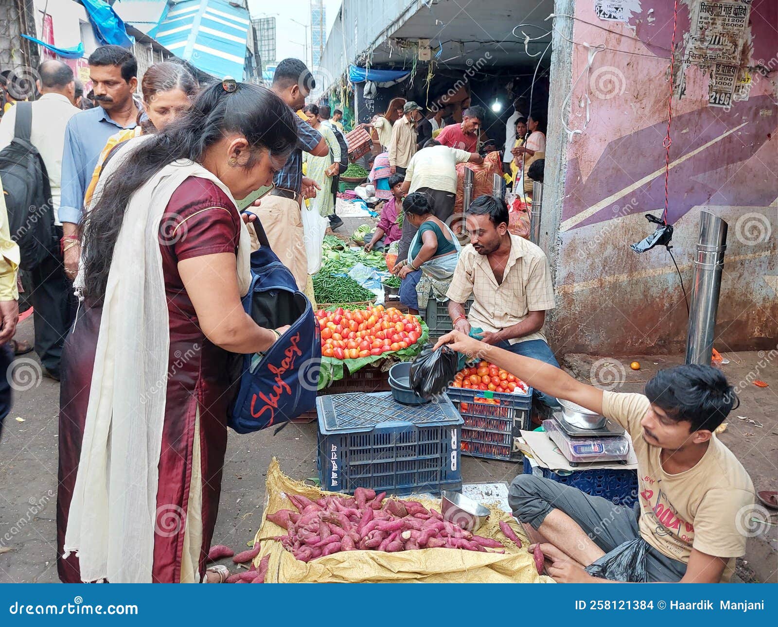 Woman Buying Vegetables from Local Indian Market in Crowd Editorial