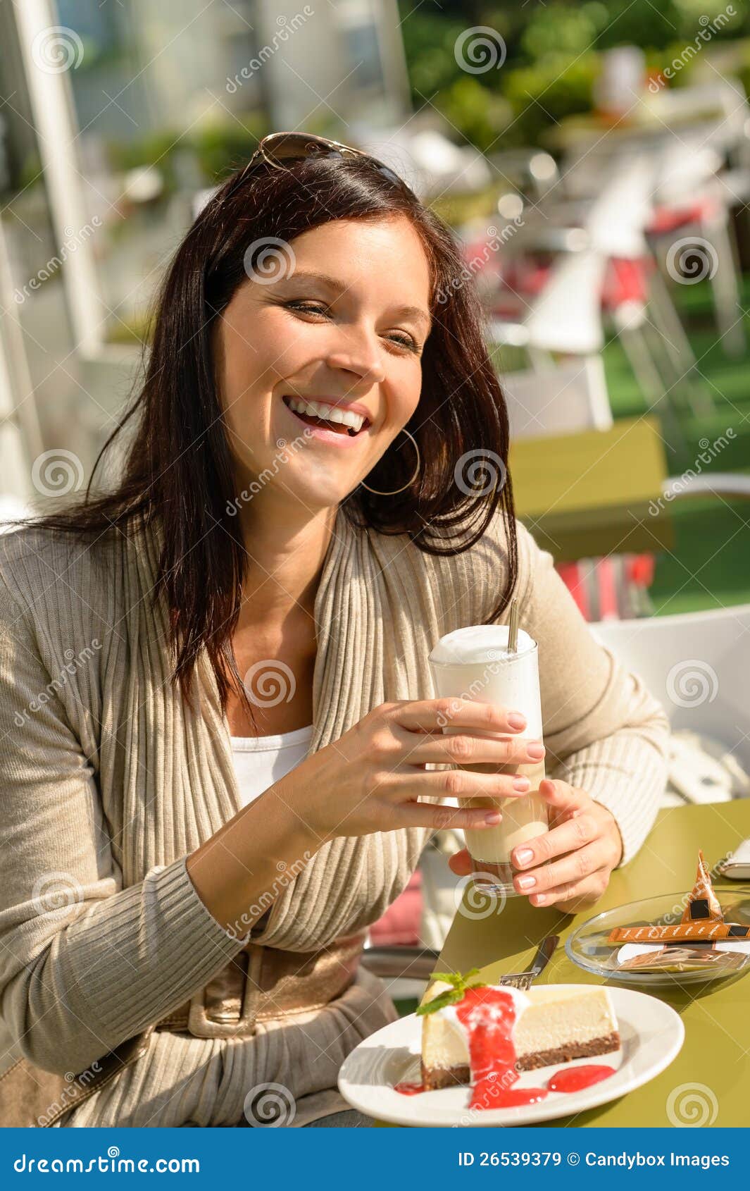 woman at cafe bar holding latte drink