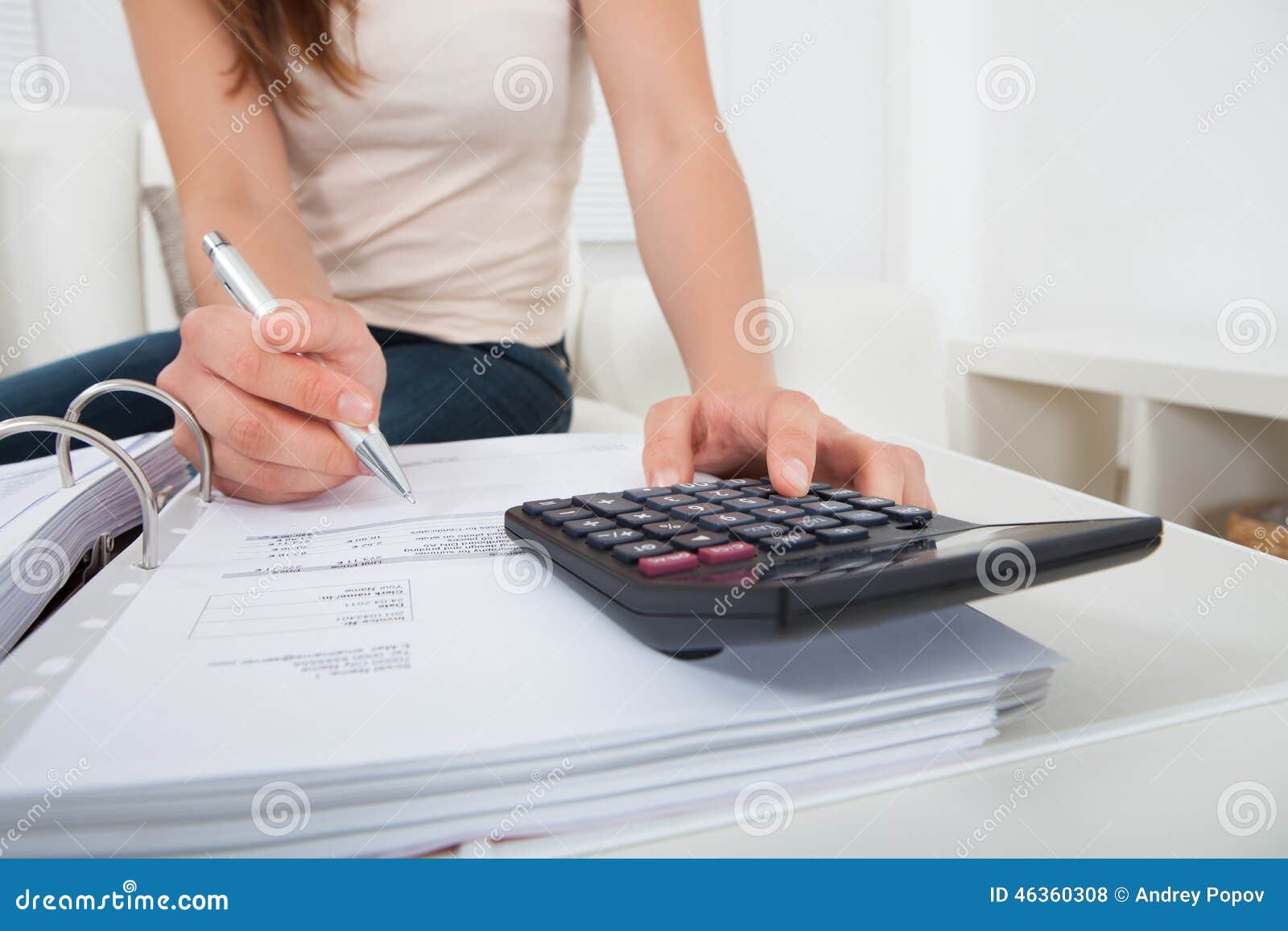 woman calculating home finances at table