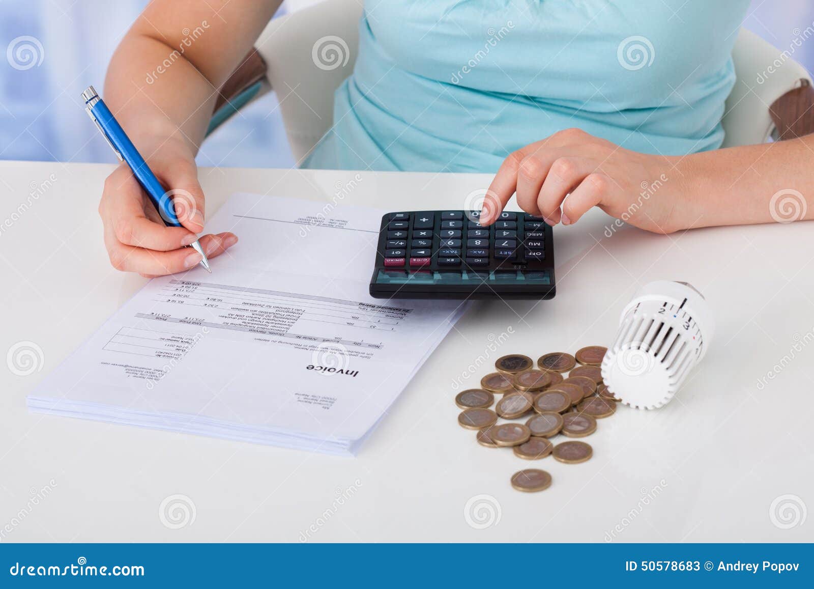woman calculating invoice by coins and thermostat at desk