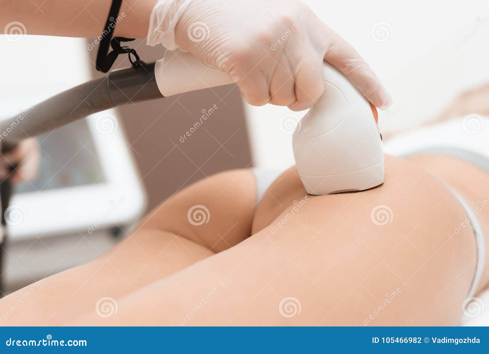 The Woman Came To the Procedure of Laser Hair Removal. the Doctor Treats  Her Buttock with a Device Stock Photo - Image of body, face: 105466982