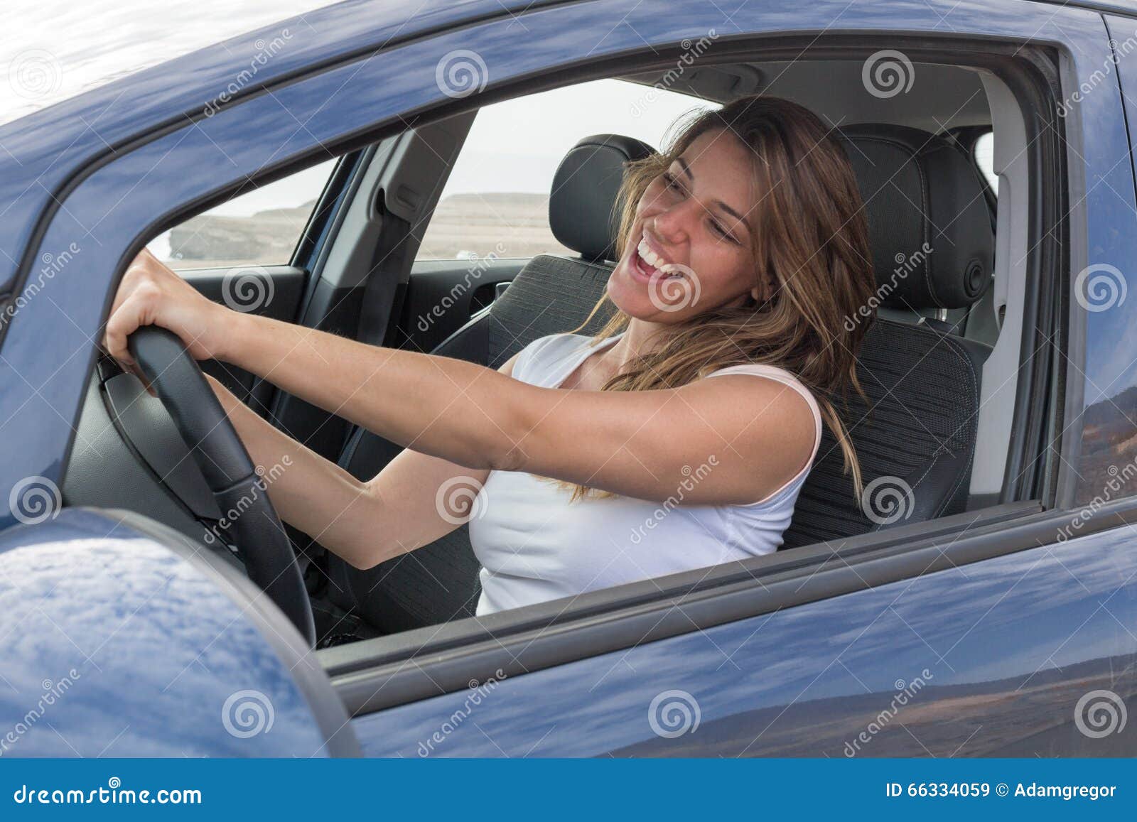 Woman in car singing stock image. Image of shirt, girl 66334059