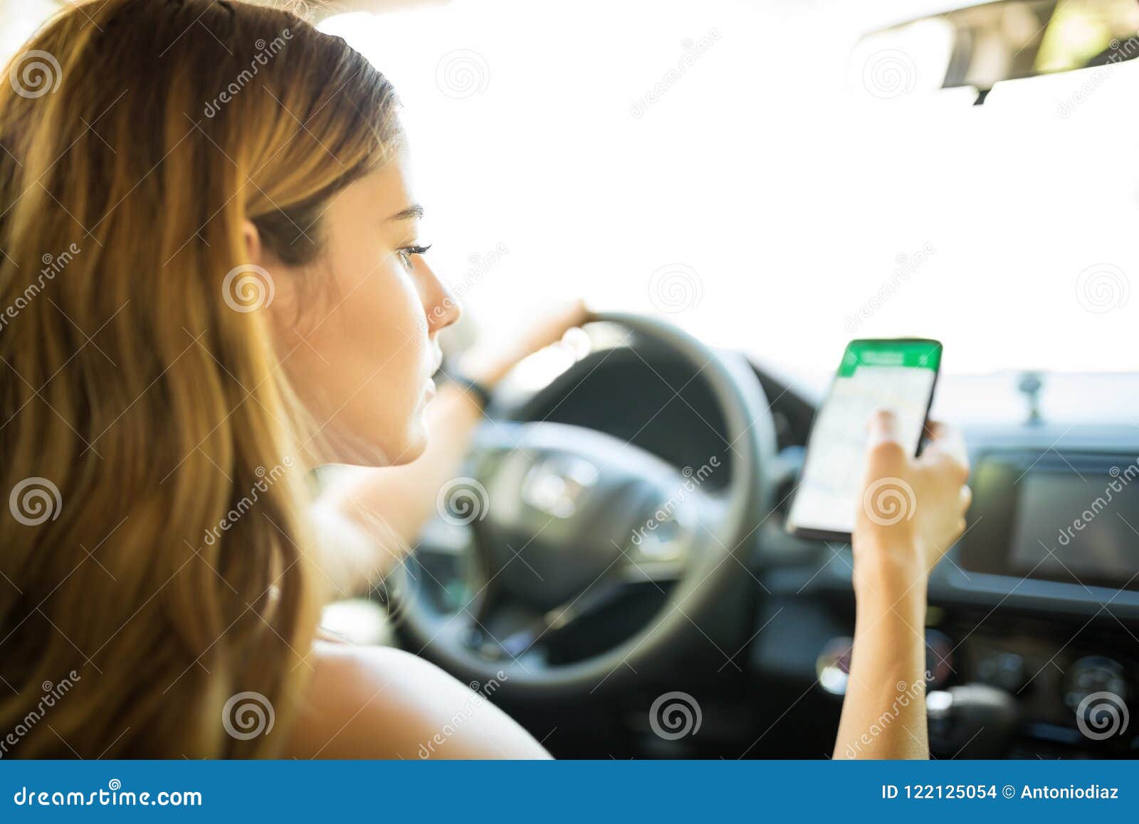 Woman in Car Using GPS Navigator on Her Phone Stock Photo Image of caucasian, route 122125054