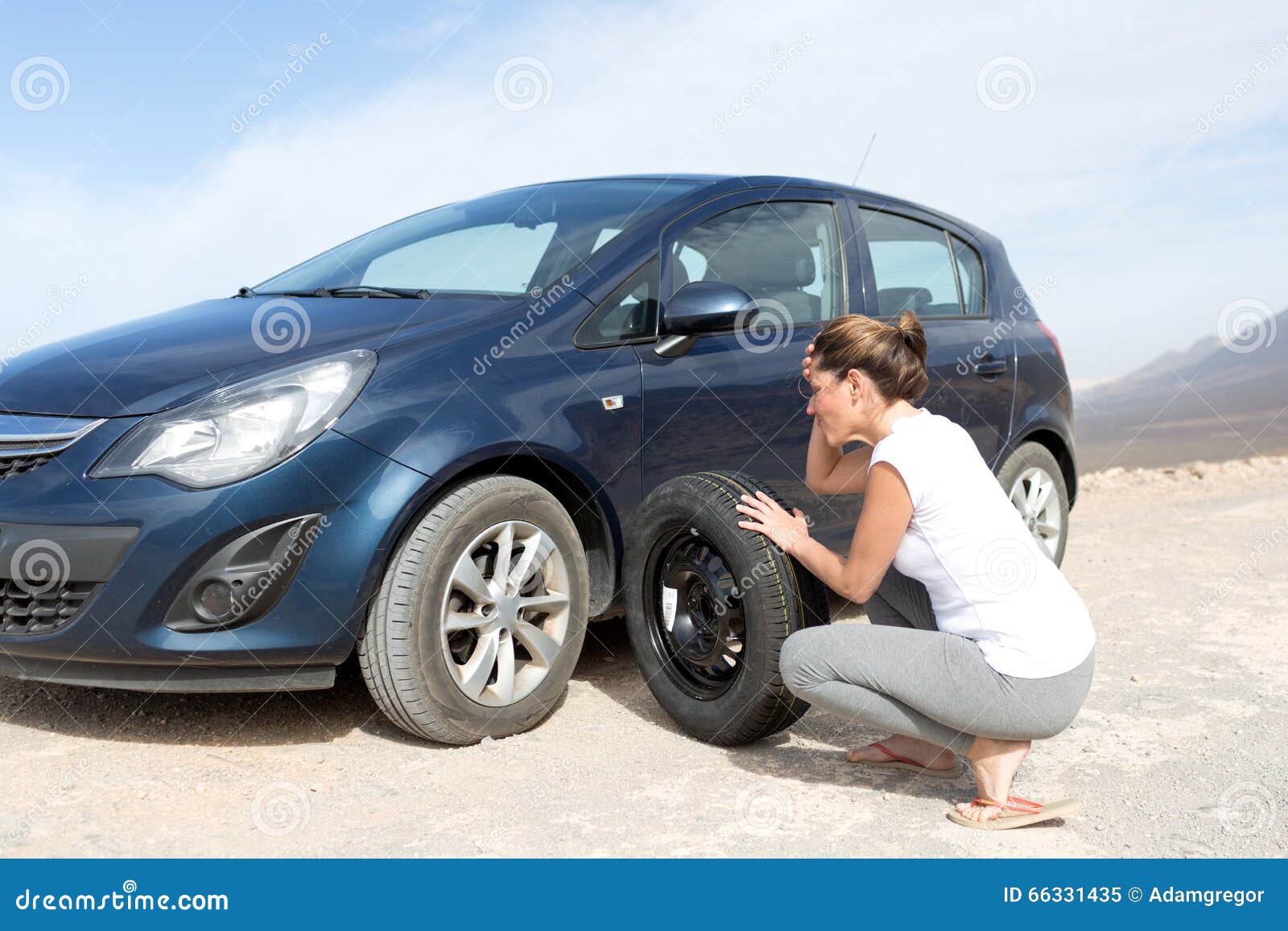 Woman changing tires stock image. Image of call, cover 66331435