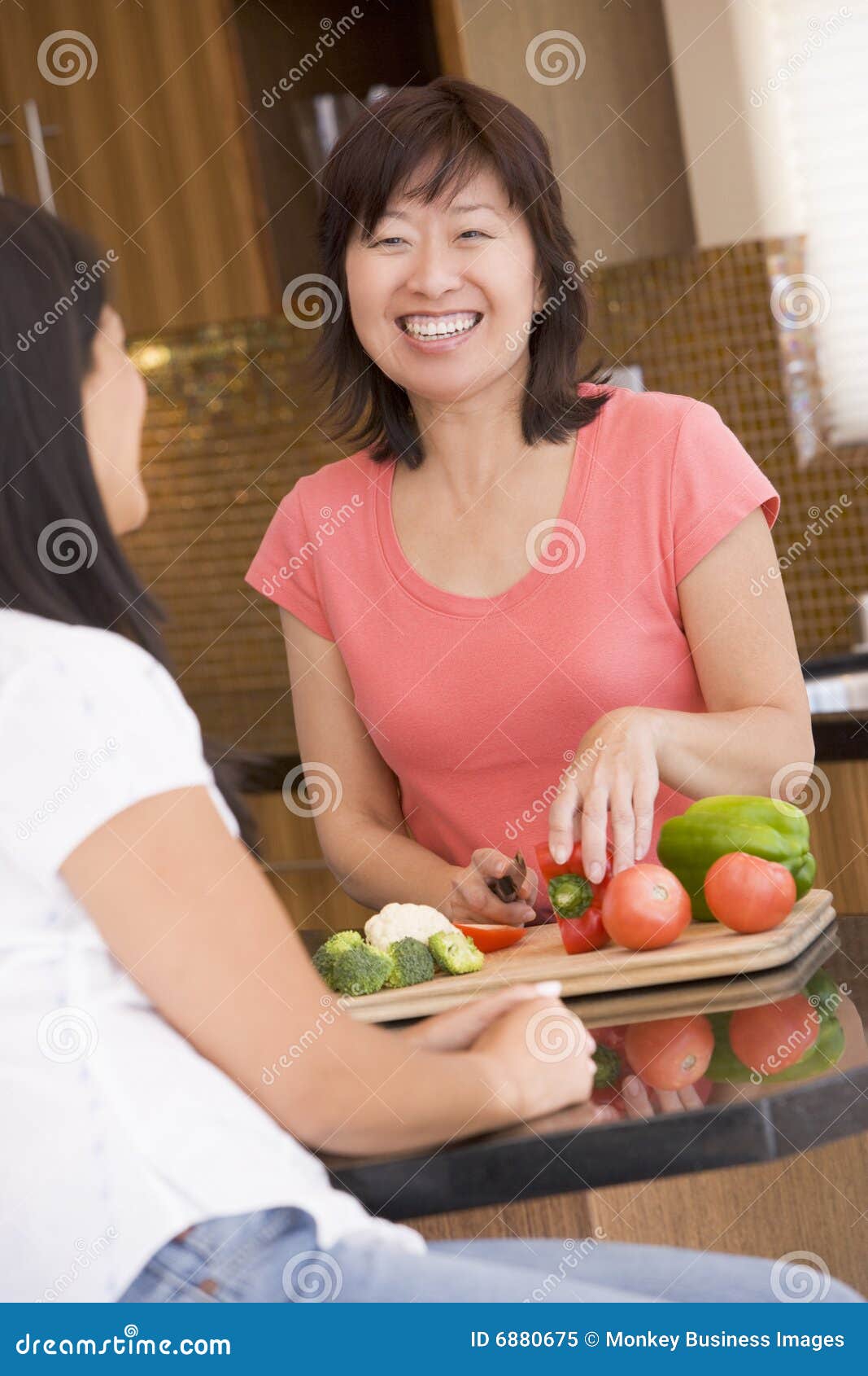 woman chatting to friend while preparing meal