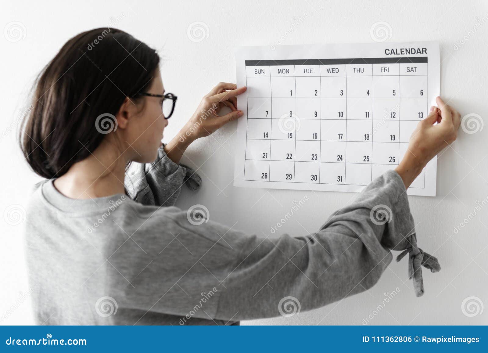 Woman Checking the Calendar on Wall Stock Photo Image of isolated