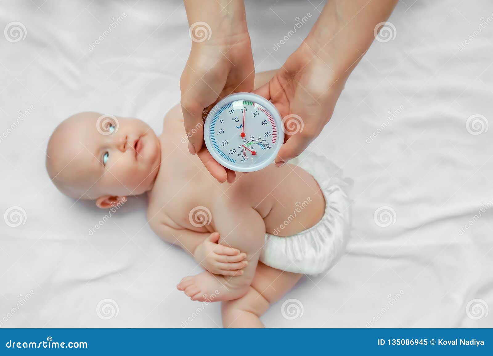 Woman Checking Temperature And Humidity In Baby Room. Concept Woman Checking Temperature And Humidity In Baby Room. Concept