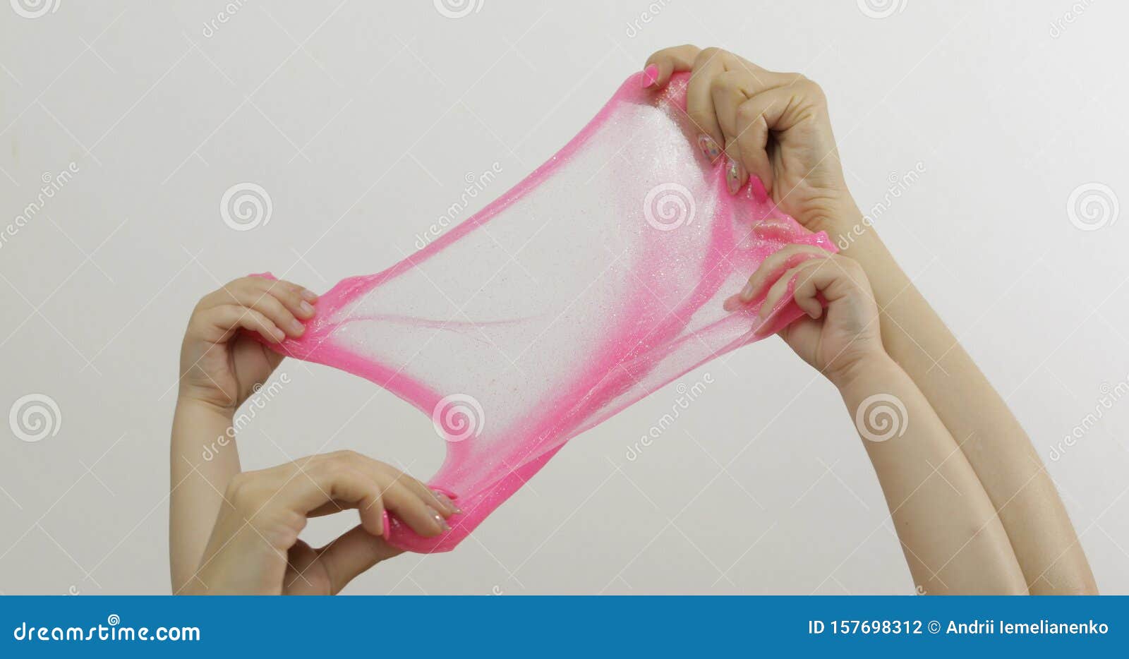 woman and child hands playing oddly pink slime on white background. antistress