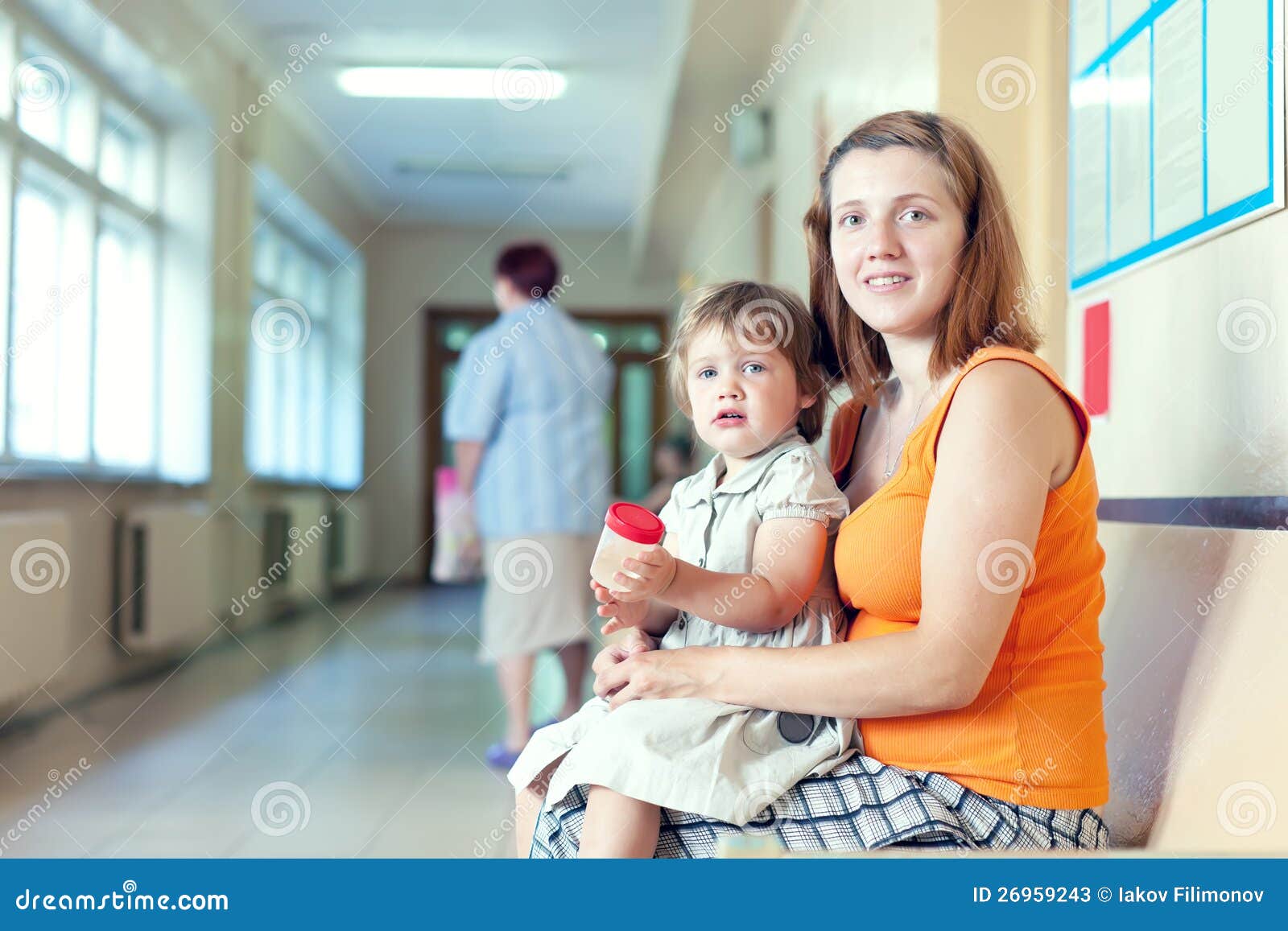 woman and child with urinalysis sample