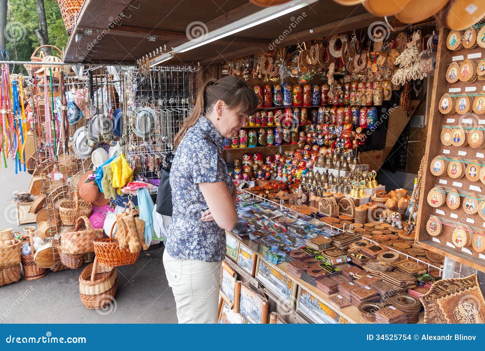 Woman Choose Russian Handmade Souvenirs At The Gift Shop 