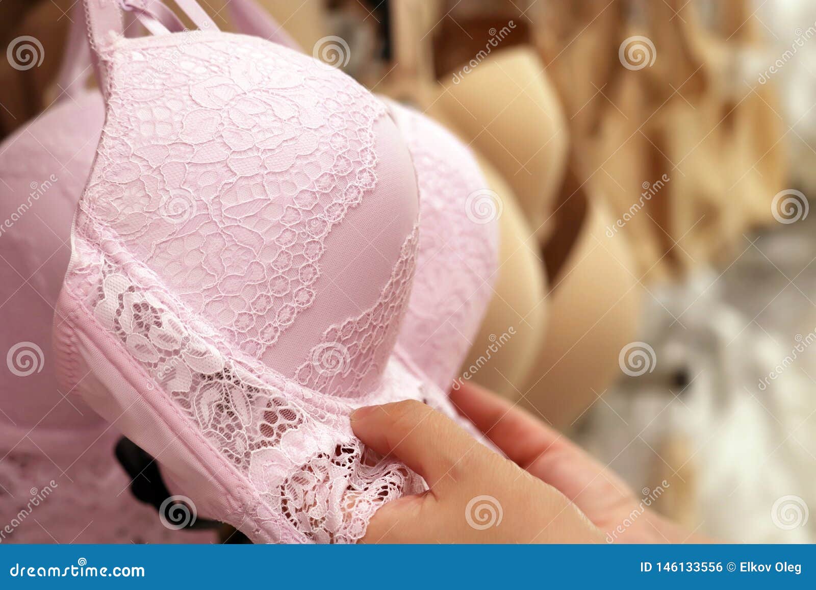 Woman Chooses Pink Lace Bra Hanging on Rack in Lingerie Store. Concept of  Shopping, Customer during Sale, Female Fashion, Differen Stock Photo -  Image of body, concept: 146133556