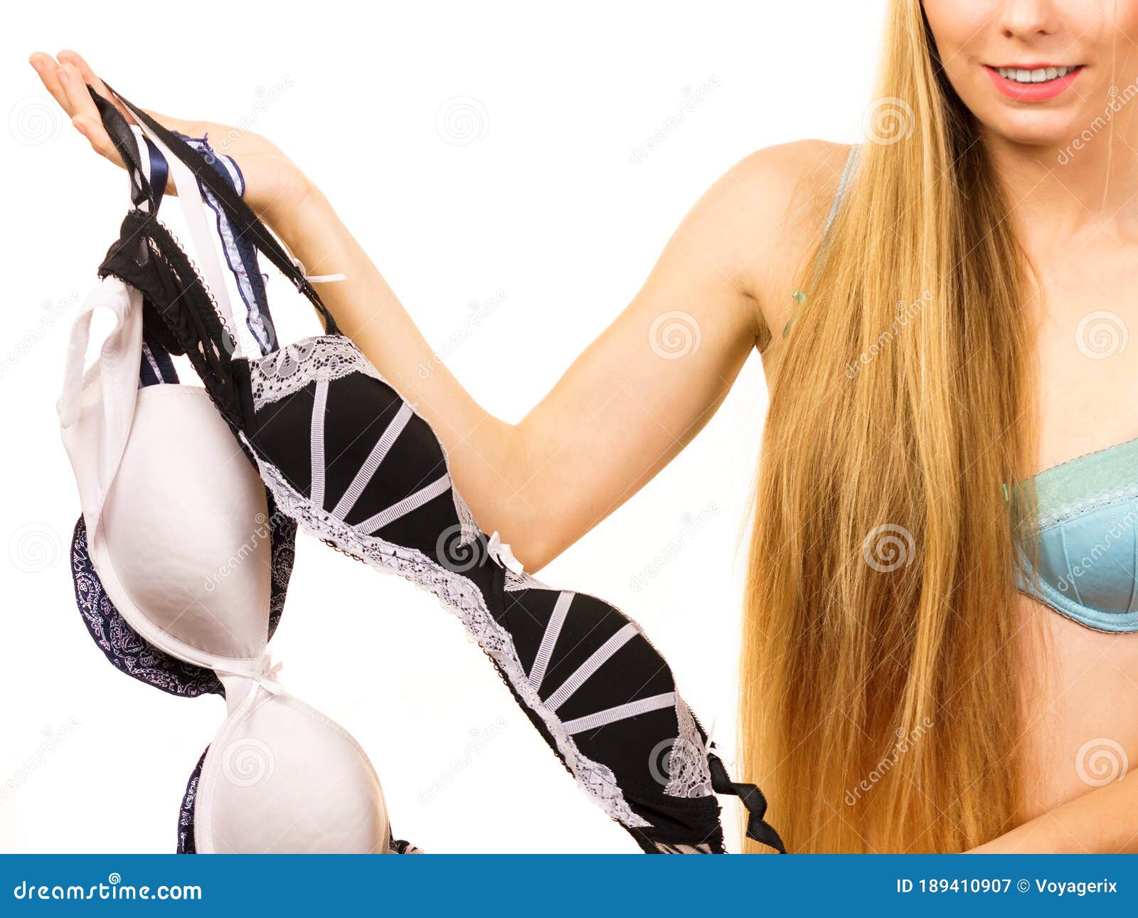 Nude woman holding bra Stock Photo - Alamy