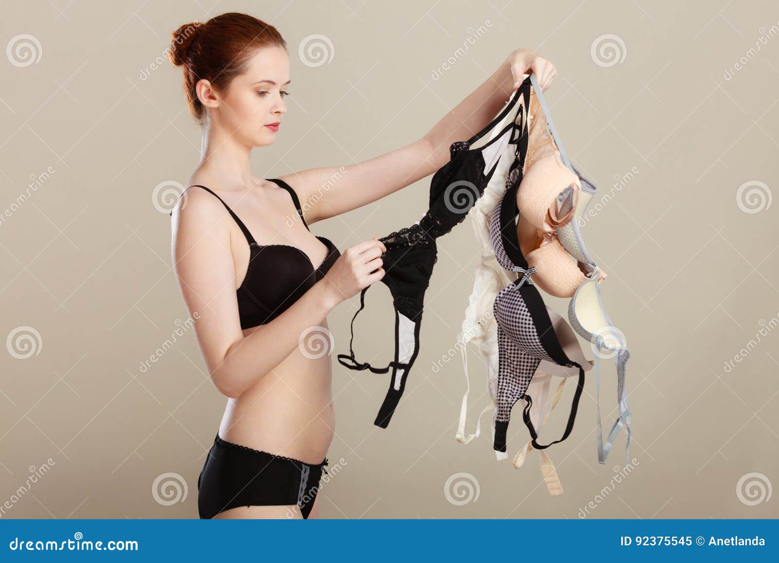 https://thumbs.dreamstime.com/z/woman-choosing-bras-to-wear-bosom-concept-slim-attractive-red-hair-wearing-black-underwear-holding-many-hand-witch-bra-92375545.jpg