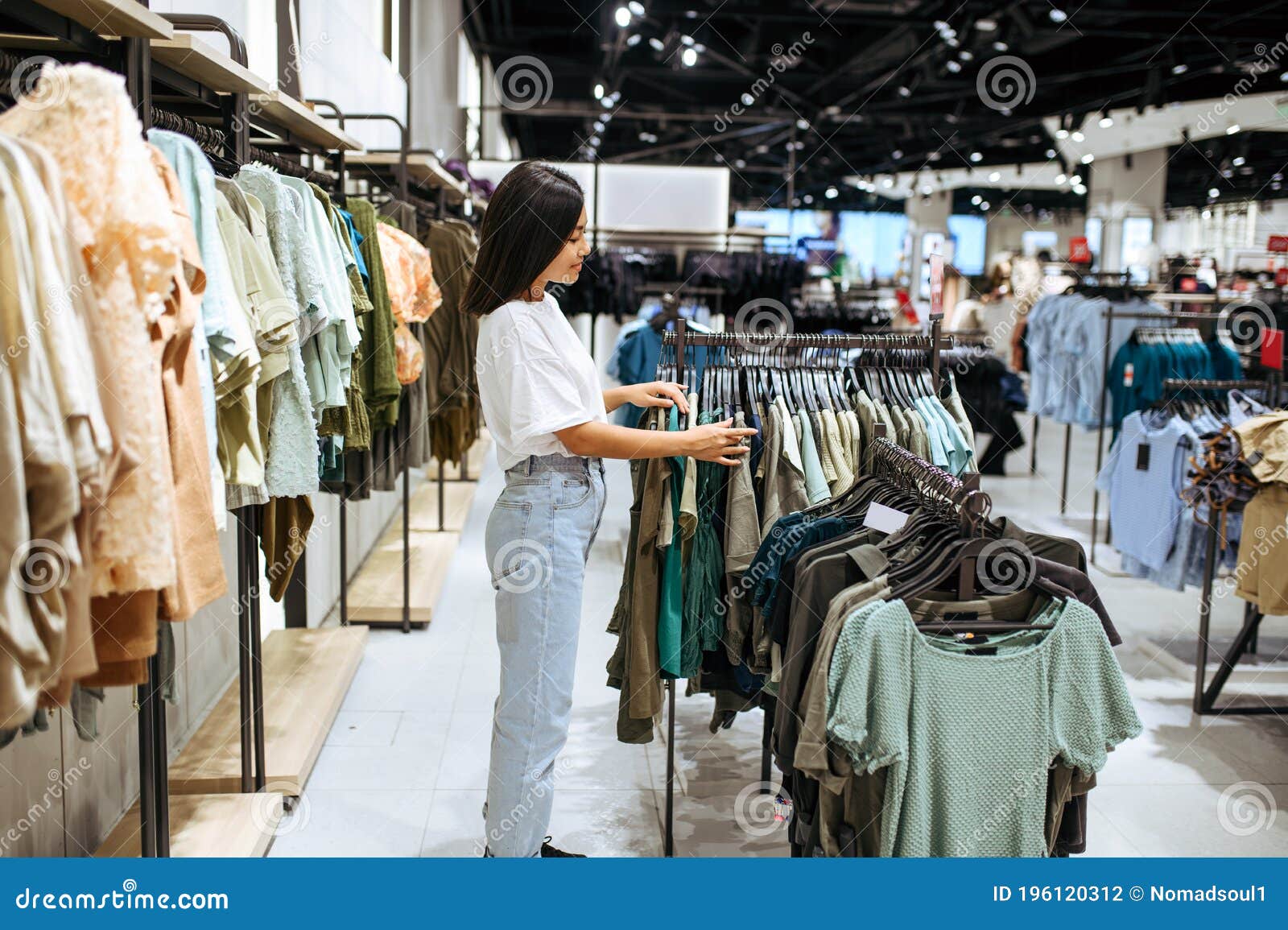 Woman Choosing Clothes in Clothing Store Stock Photo - Image of mall ...