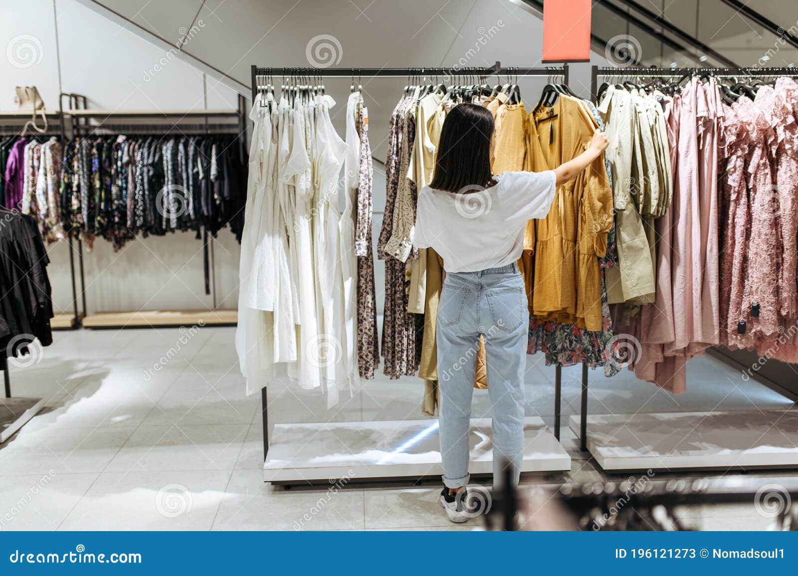 Woman Choosing Elegant Dress in Clothing Store Stock Image - Image of ...