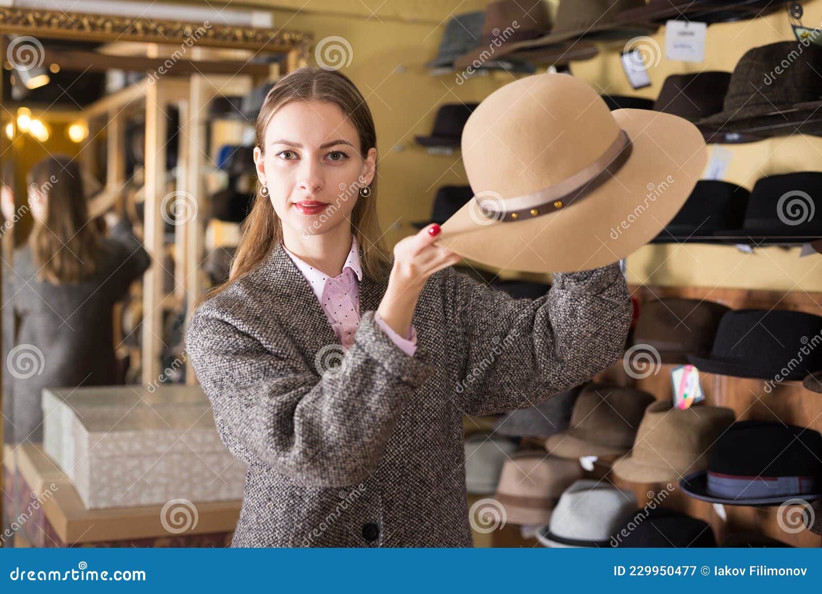 Woman Choosing Hat in Store Stock Image - Image of emotional, classic ...