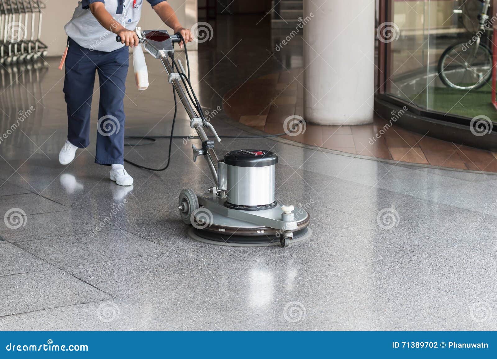 woman cleaning the floor with polishing machine