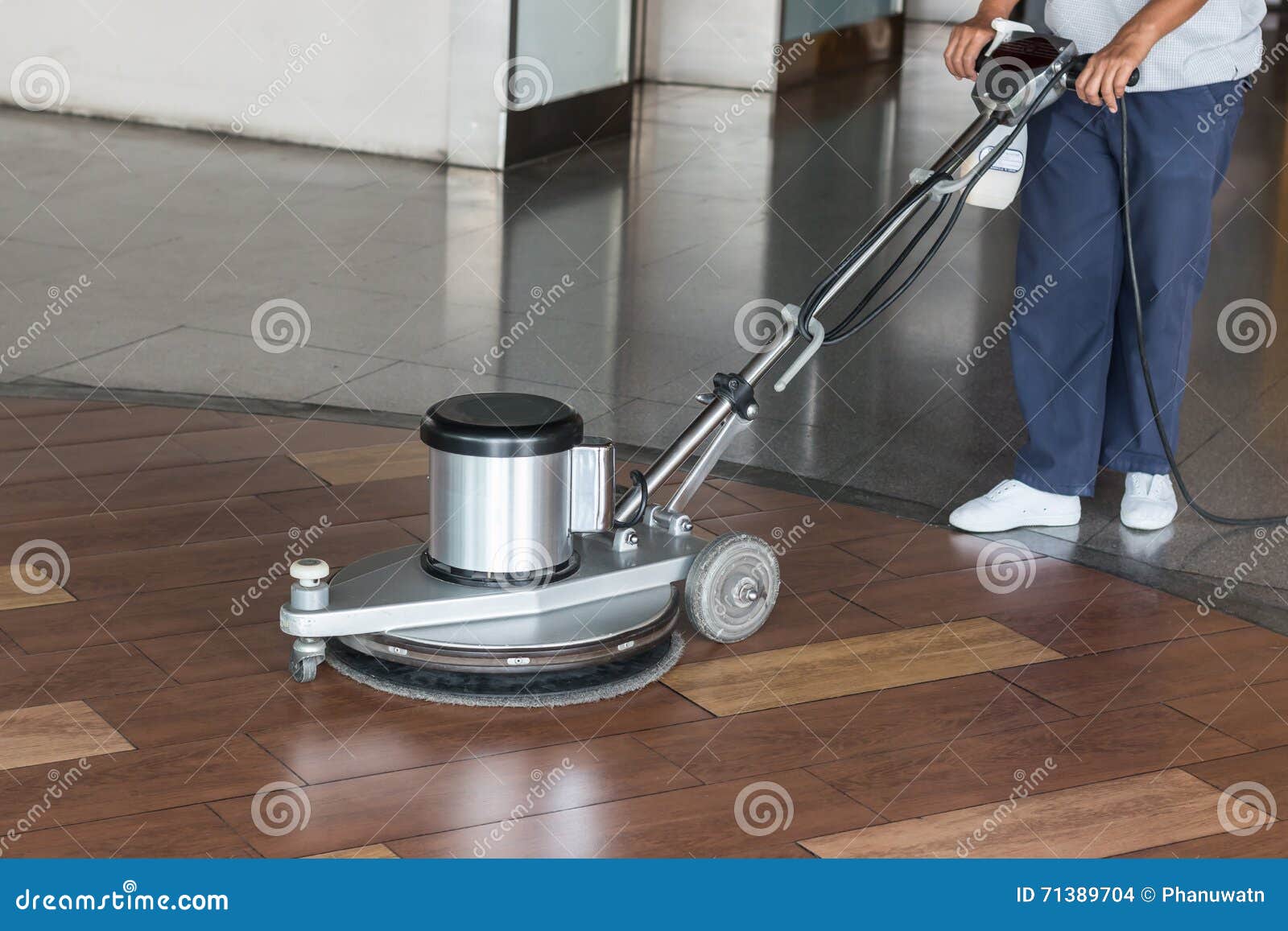 woman cleaning the floor with polishing machine