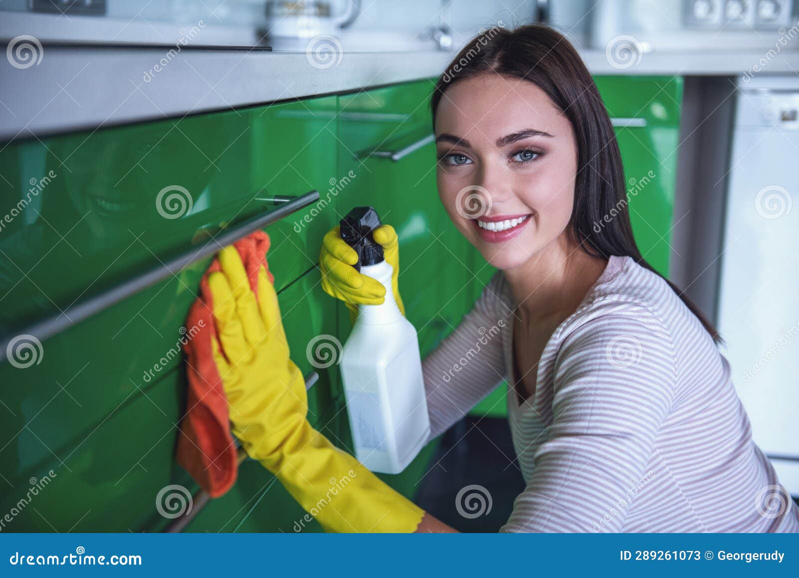 Woman cleaning her kitchen stock image. Image of casual 289261073