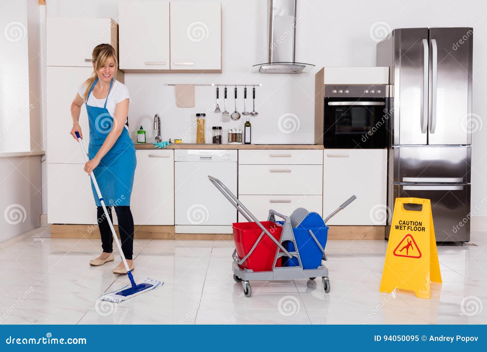woman cleaning kitchen floor with mop stock image - image of apron