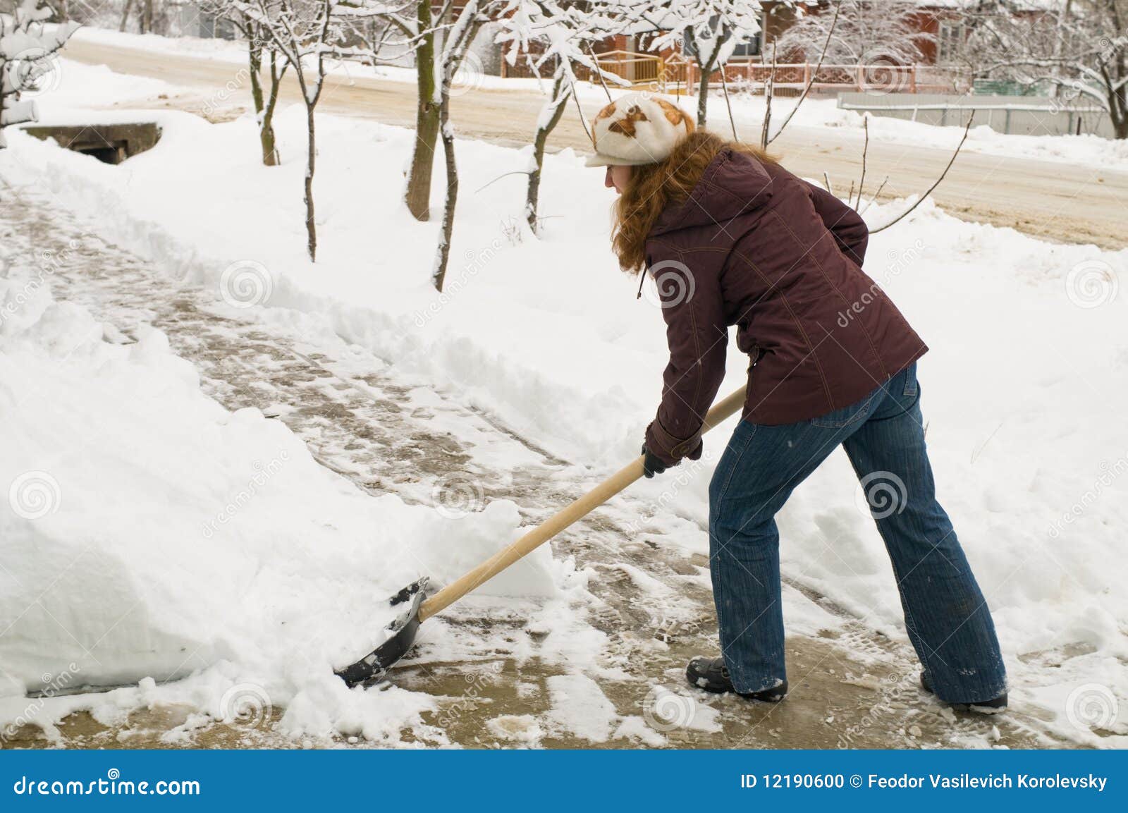 the woman cleans snow.