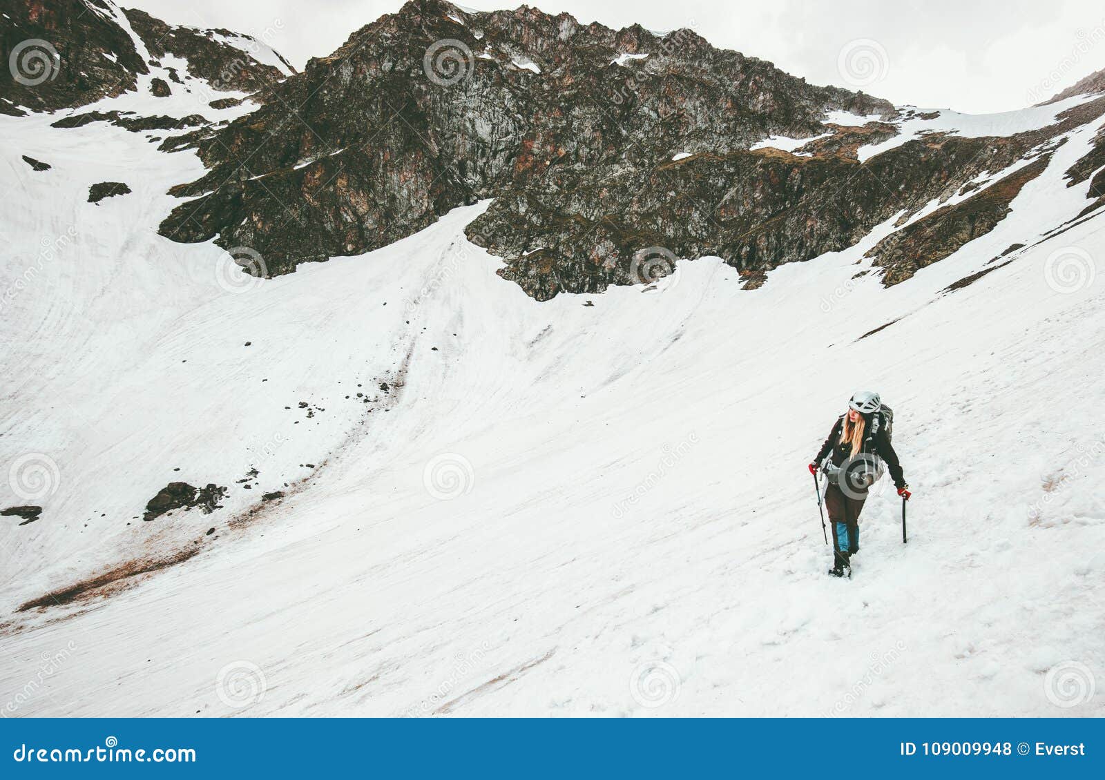 woman climbing with ice axe mountaineering travel