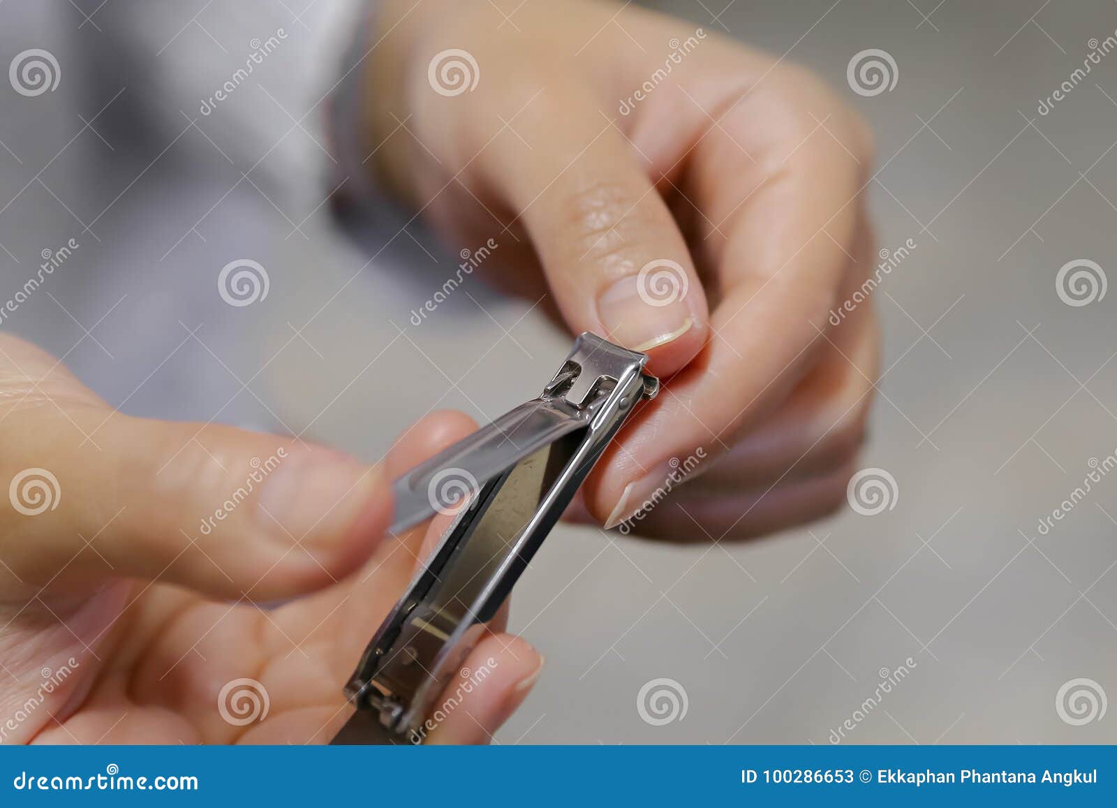 woman clipping fingernail