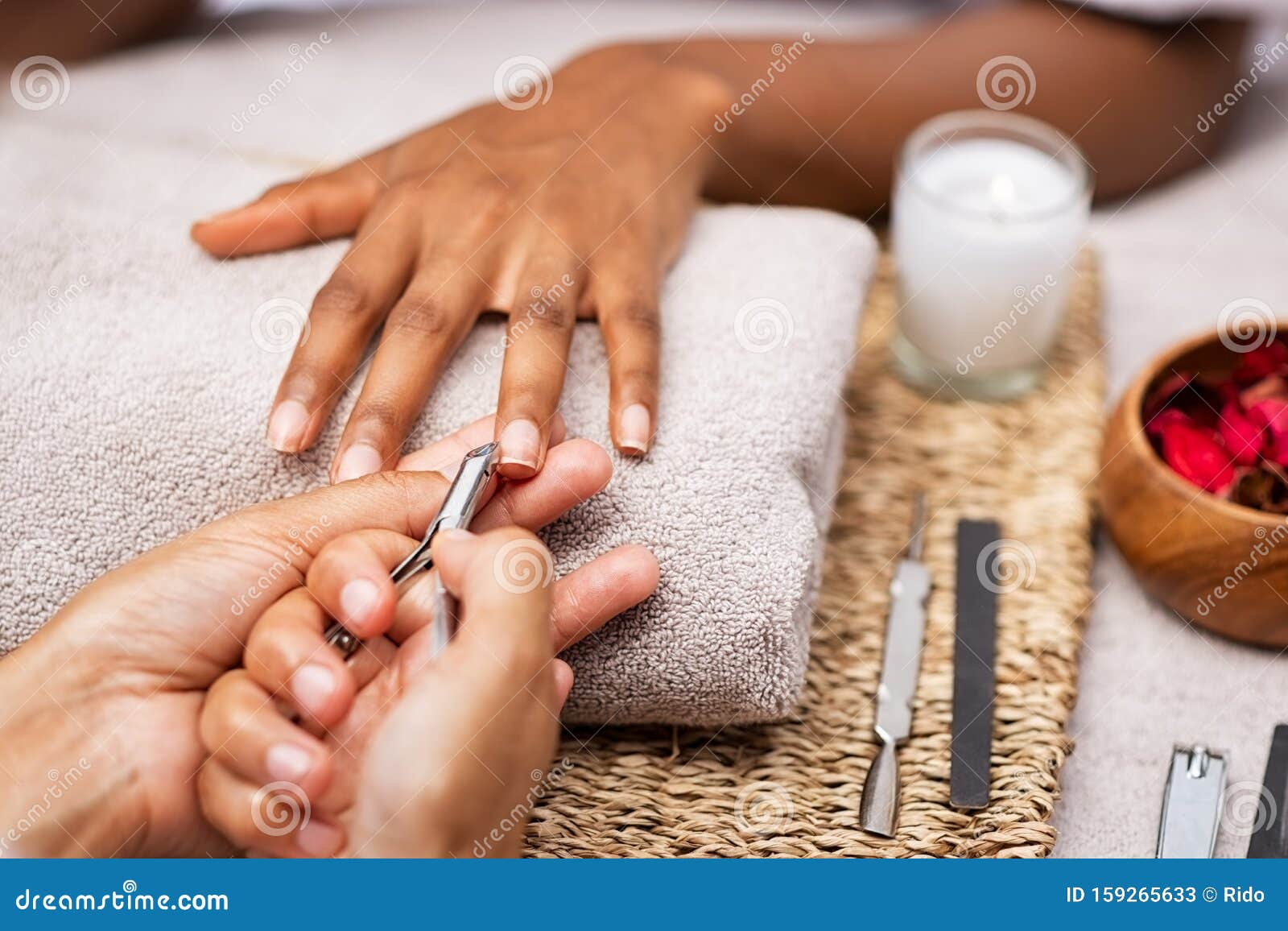 woman clipping nails at salon