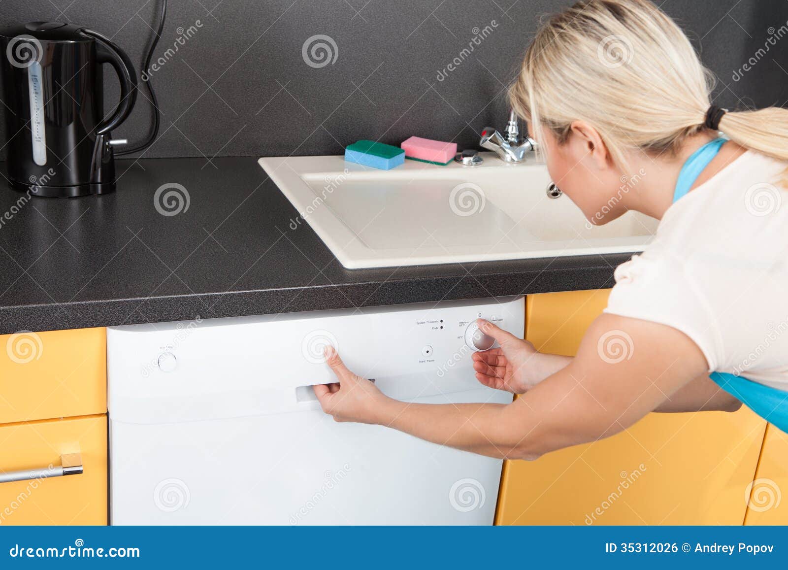 Woman Closing Dishwasher stock photo. Image of convenient 35312026
