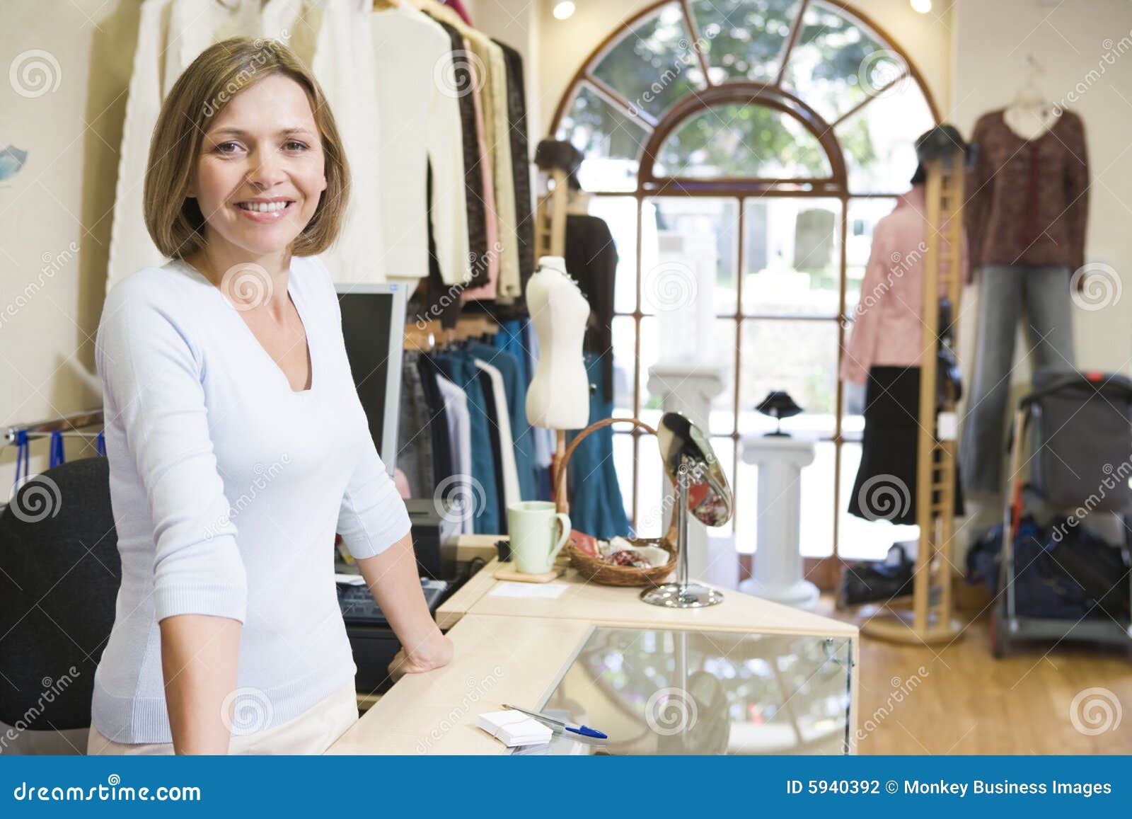 woman at clothing store smiling