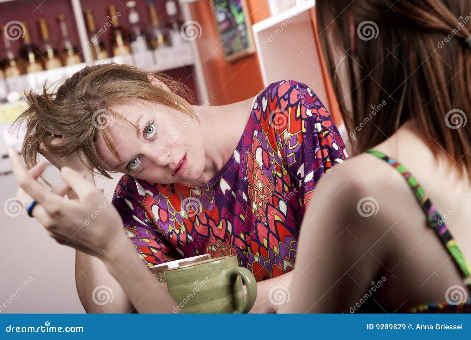woman in coffee house bored by companion