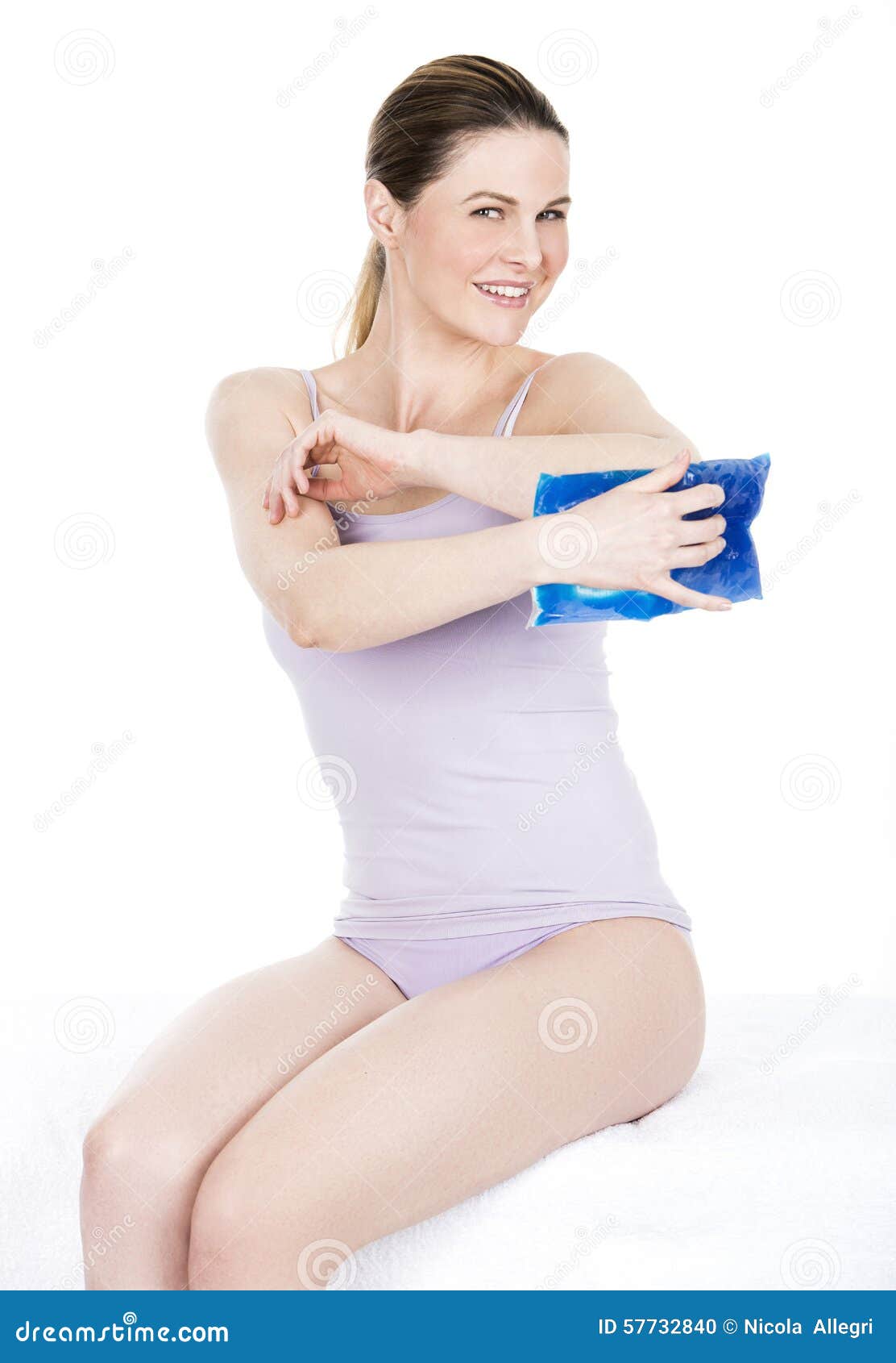 Woman with Cold Hot Pack on Elbow for Therapeutic Relief Stock Photo