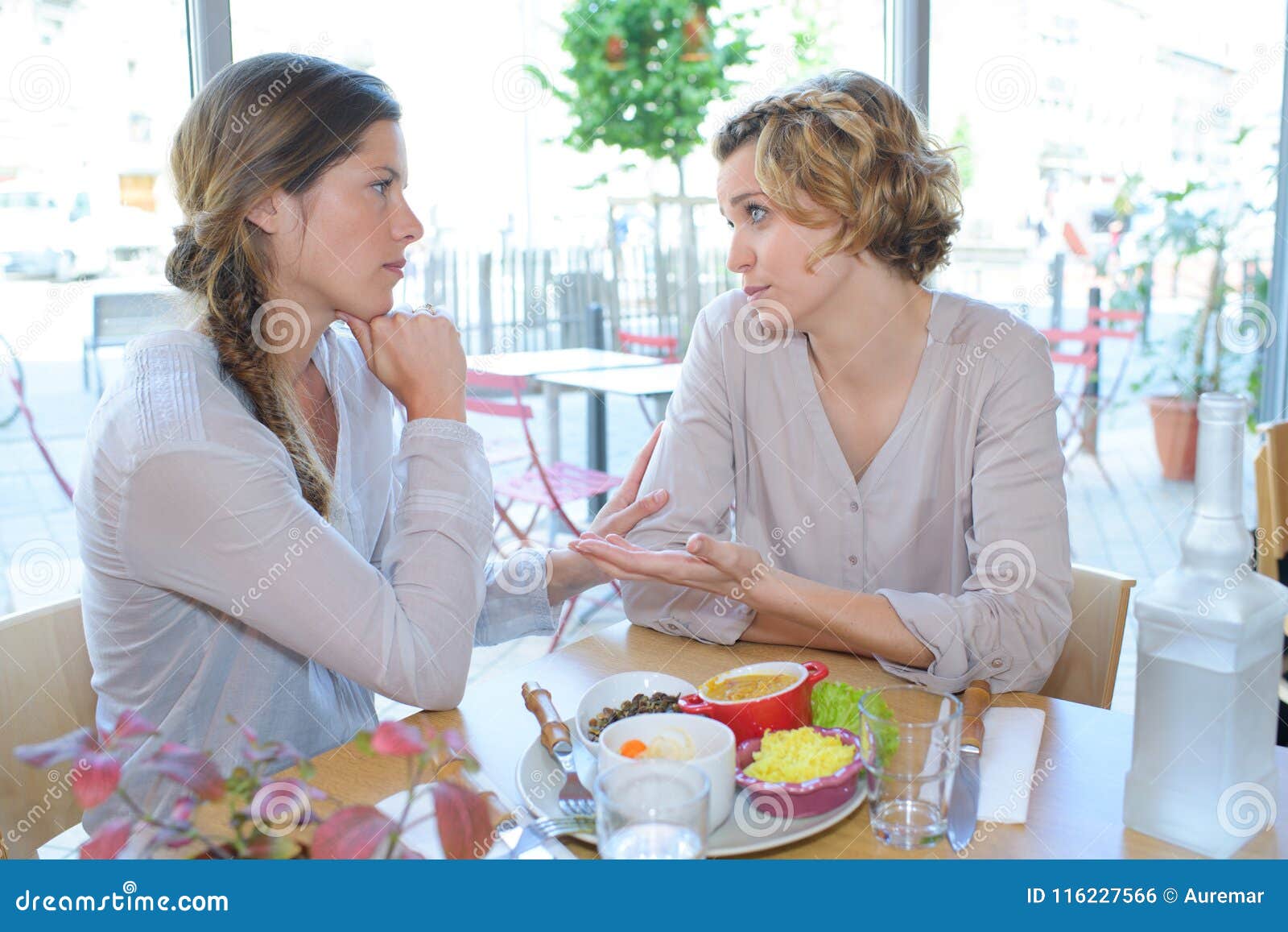 woman comforting friend in cafe