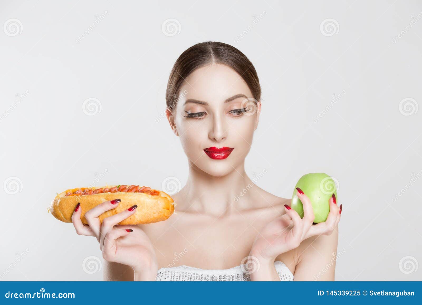 Woman Compare Tasty Unhealthy Burger Sandwich Hotdog In Hand And Green ...