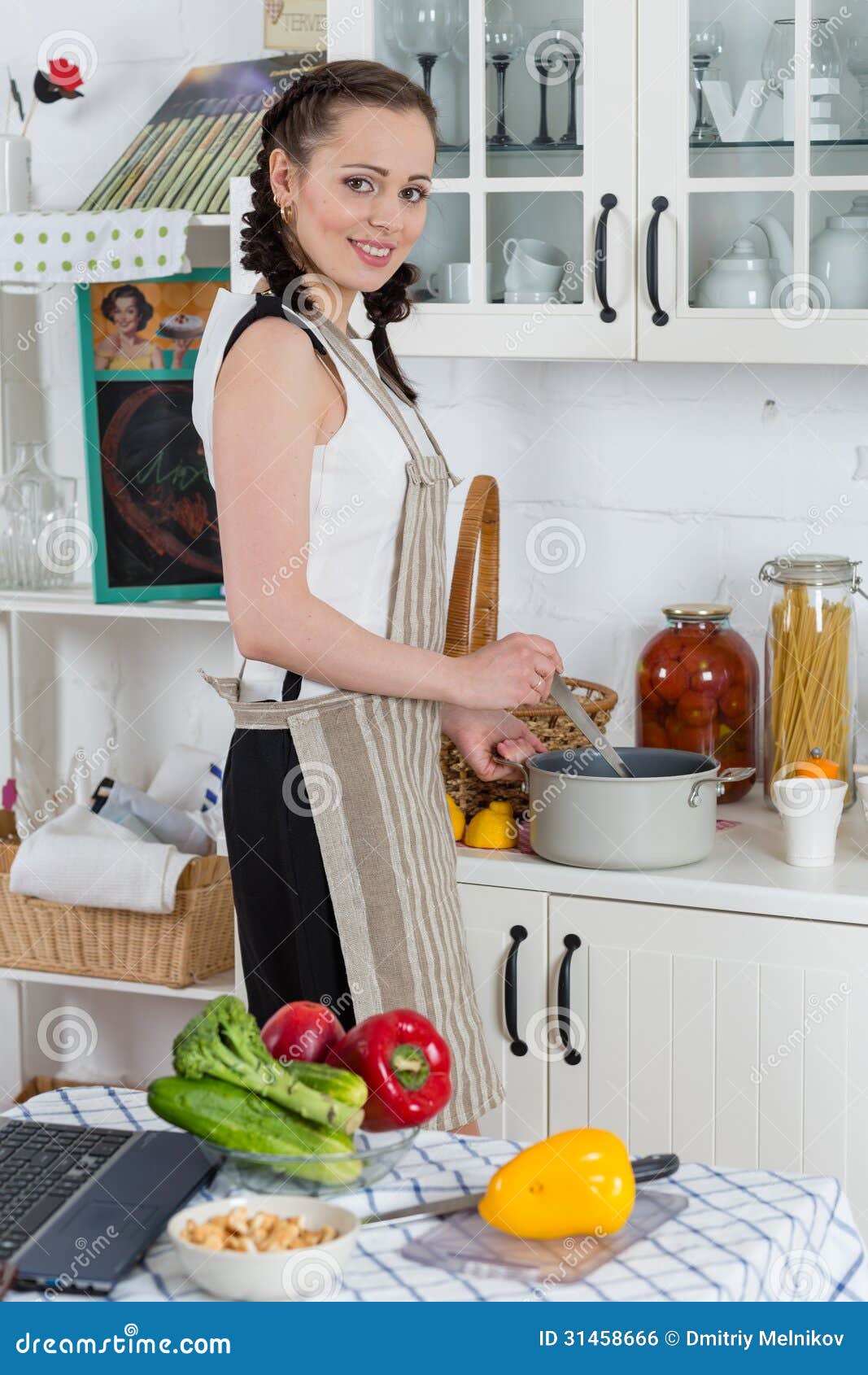 Young Woman In A Dotted Biege Apron Cooking Soup In The 