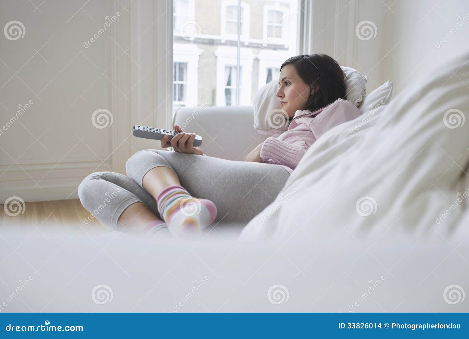 woman on couch and watching tv
