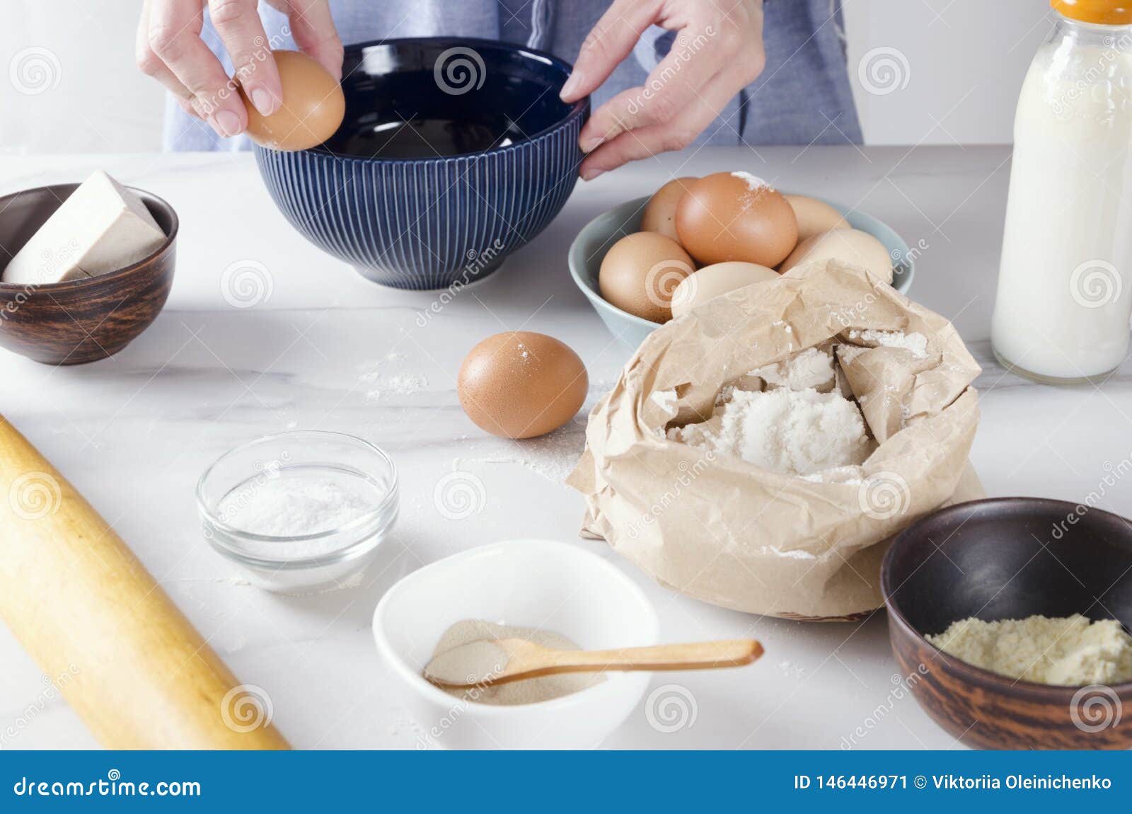 Woman Cracking an Egg into the Blue Bowl, Baking Cake Process.Base