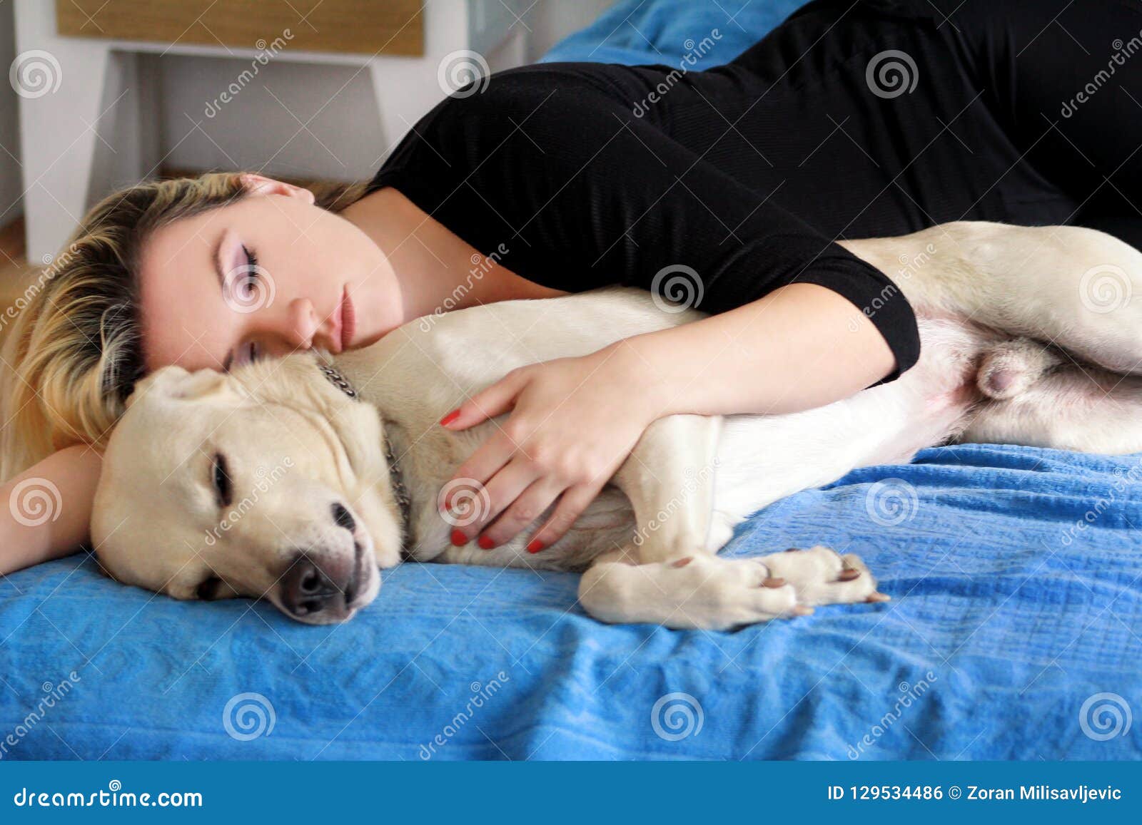 Woman with Cute Dogs at Home. Handsome Girl Resting and Sleeping with