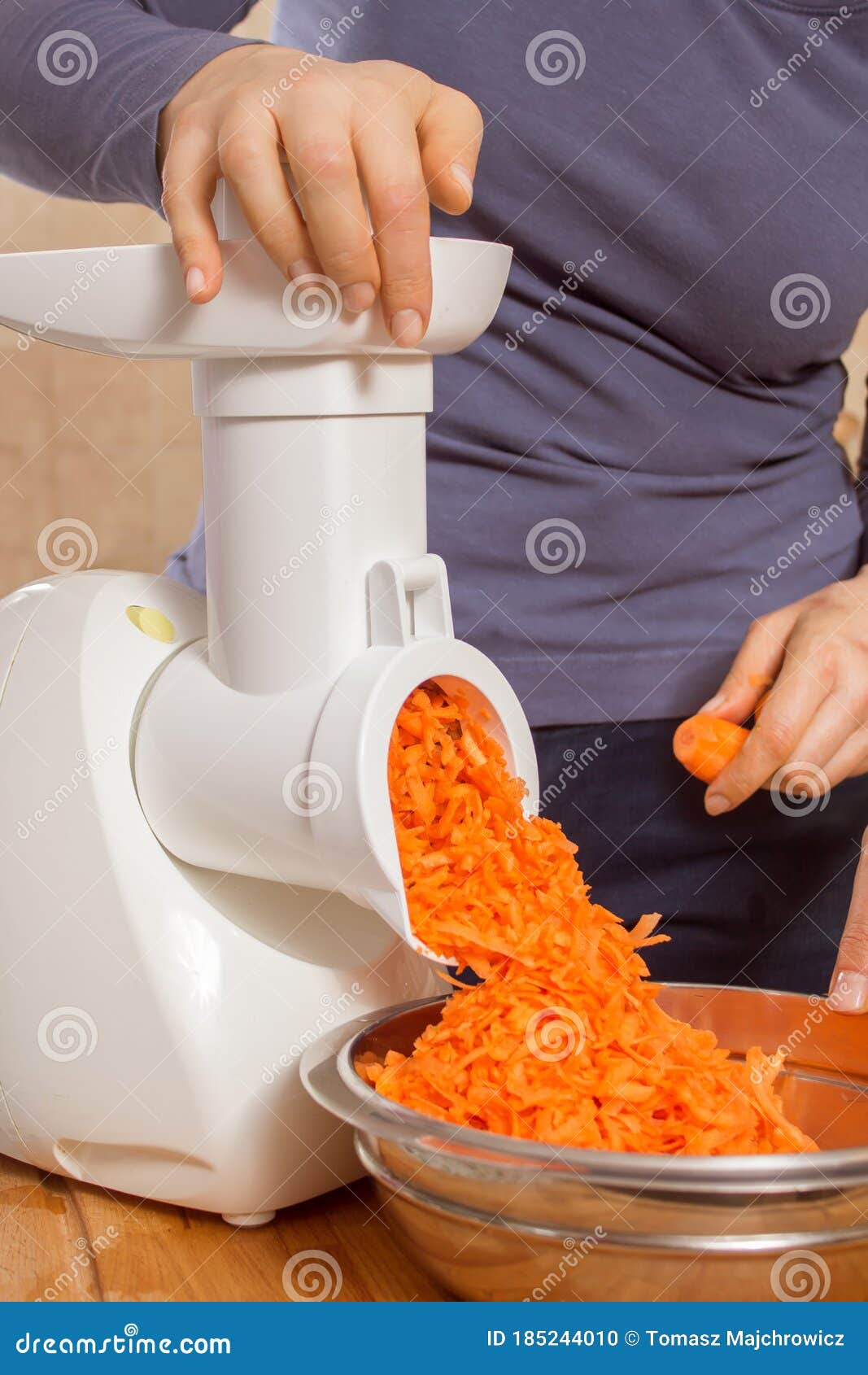 Woman Cuts the Carrot into Small Pieces Using an Electric Chopper. Stock  Photo - Image of razor, cutting: 185244010