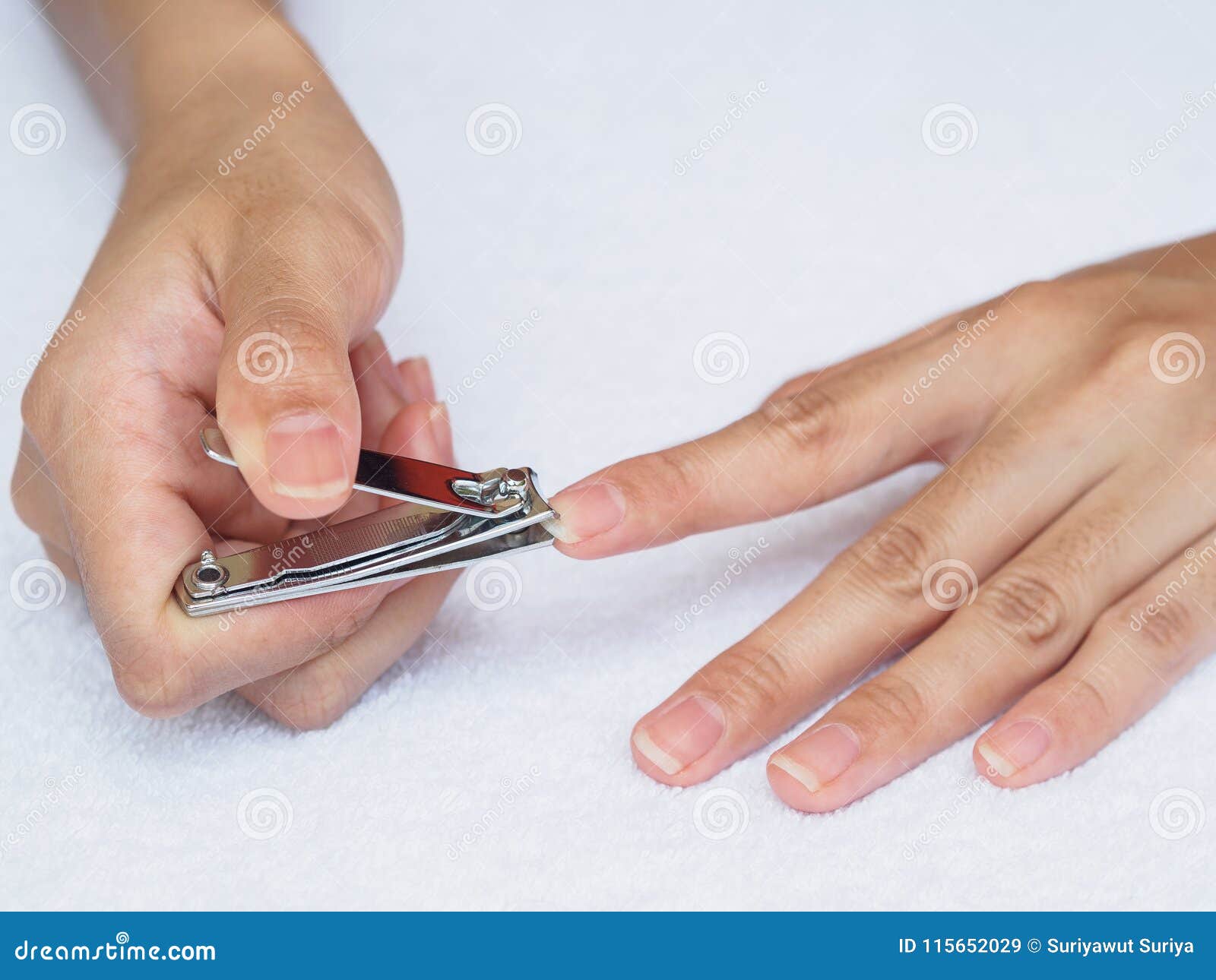 Woman Cutting Nails Using Nail Clipper on White Background. Heal Stock ...