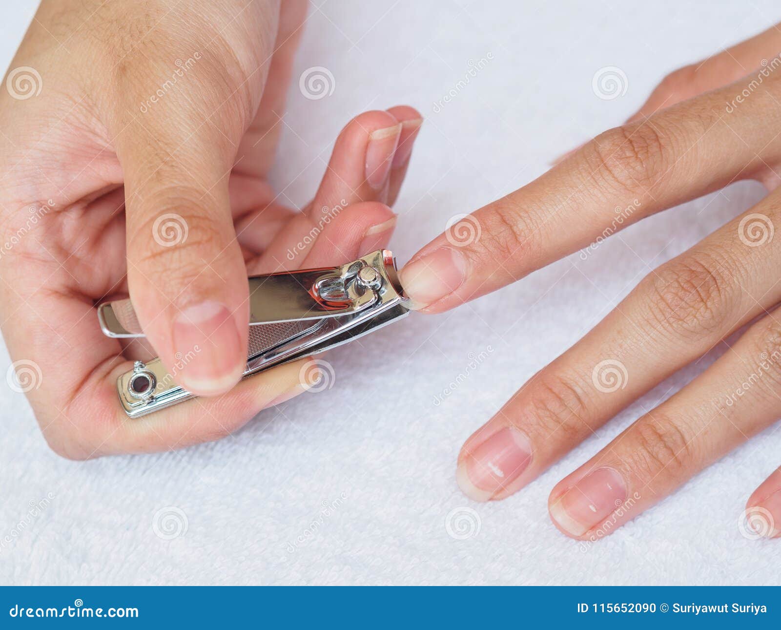 Woman Cutting Nails Using Nail Clipper on White Background. Heal Stock ...