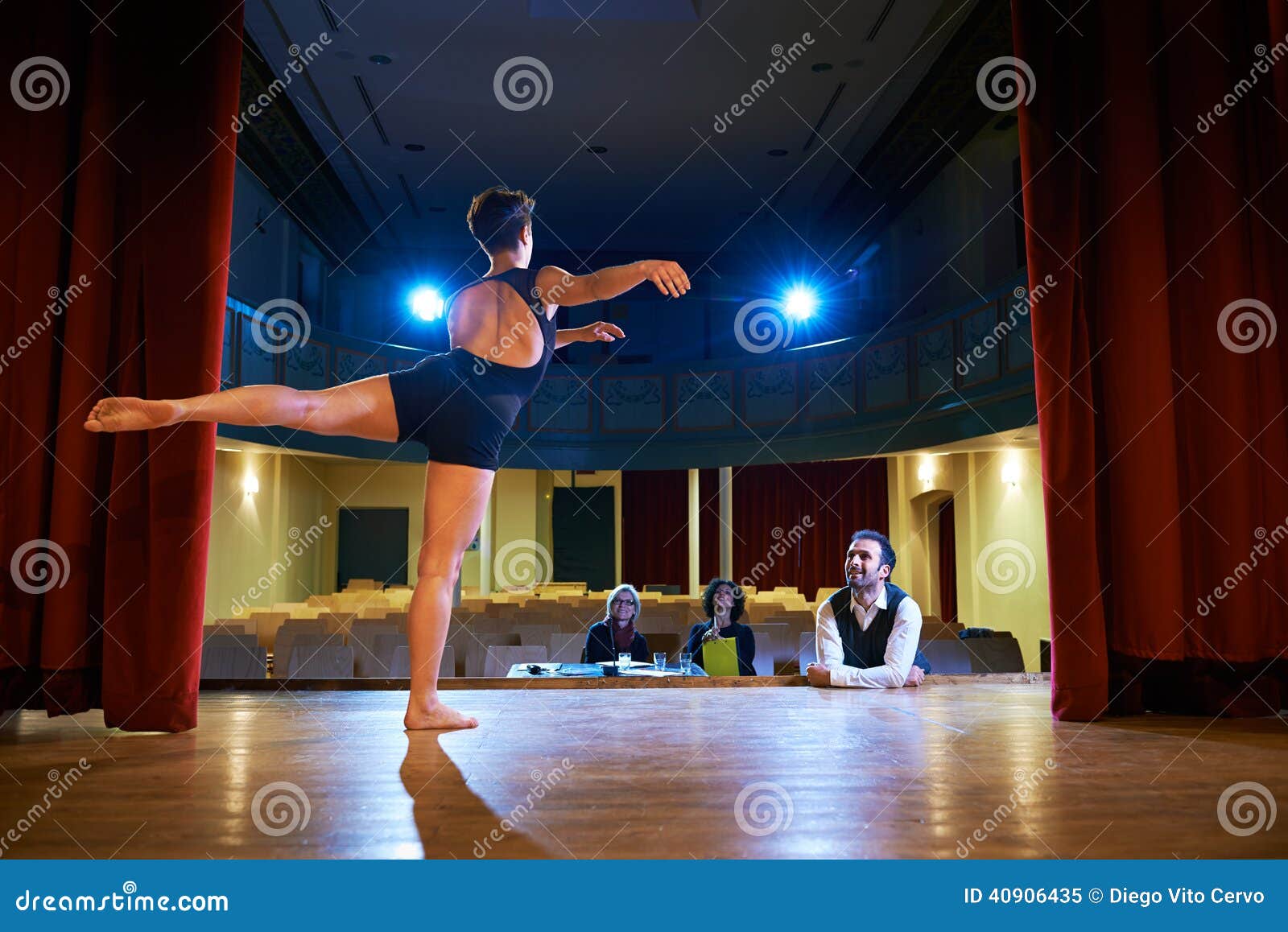 woman dancing for audition with jury in theater