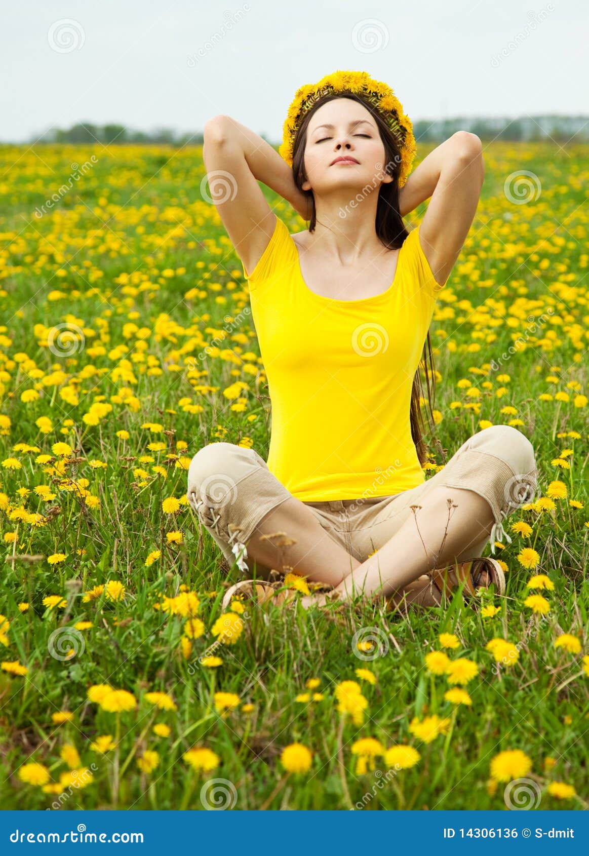 Young brunette woman in dandelion