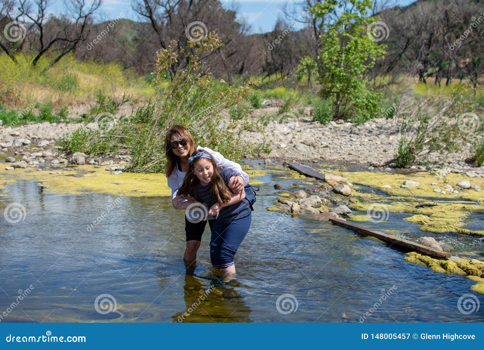 Woman and Daughter Standing and Laughing Tother while Playing i