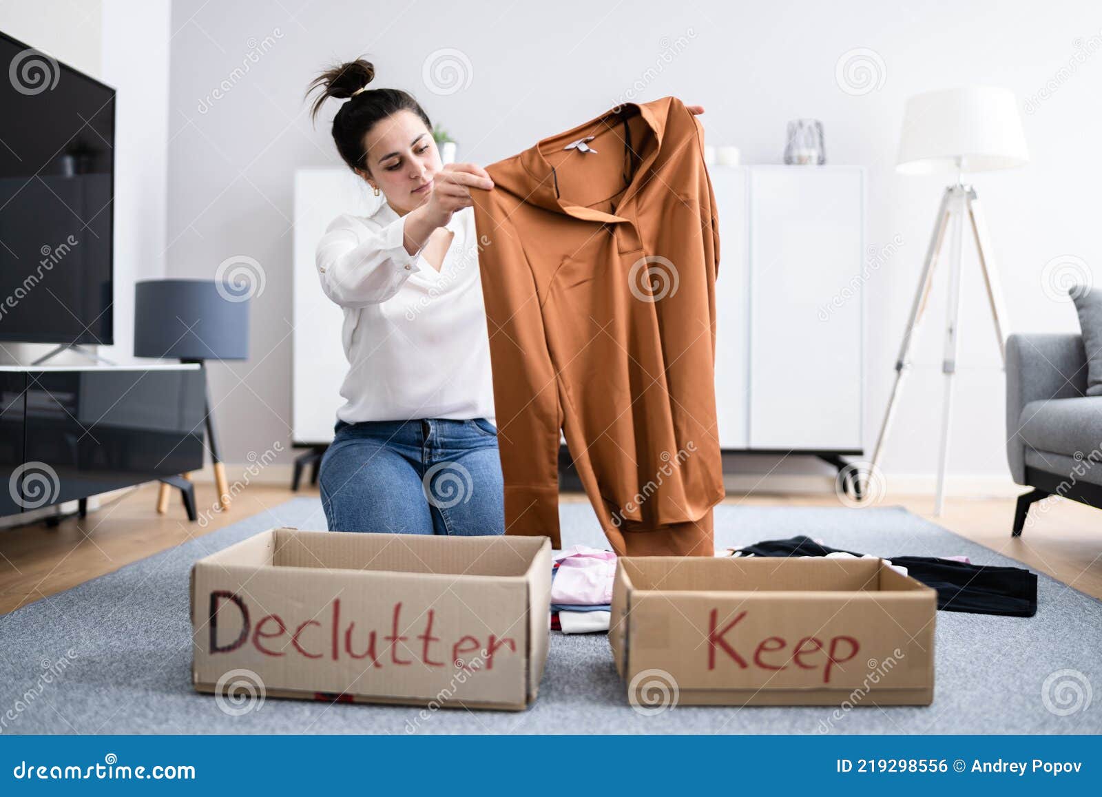 woman decluttering clothes, sorting