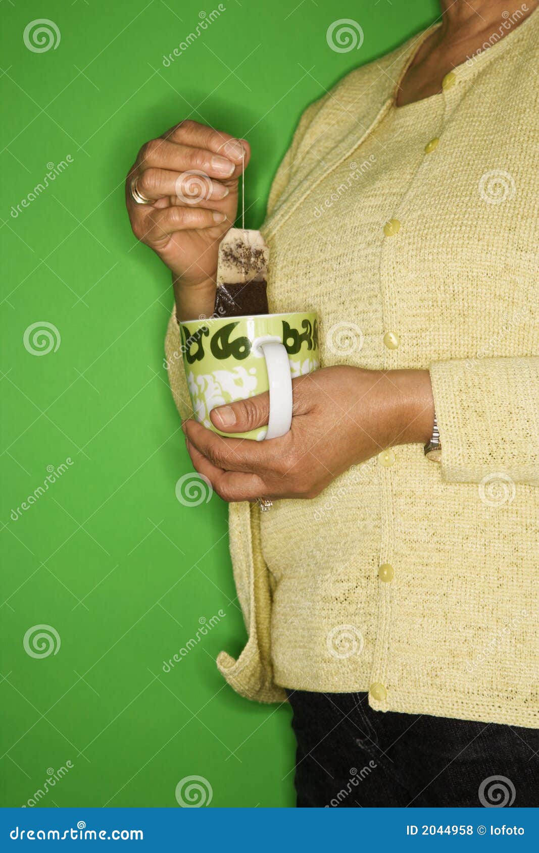 Woman Dipping Tea Bag in Mug. Stock Photo Image of mature, african
