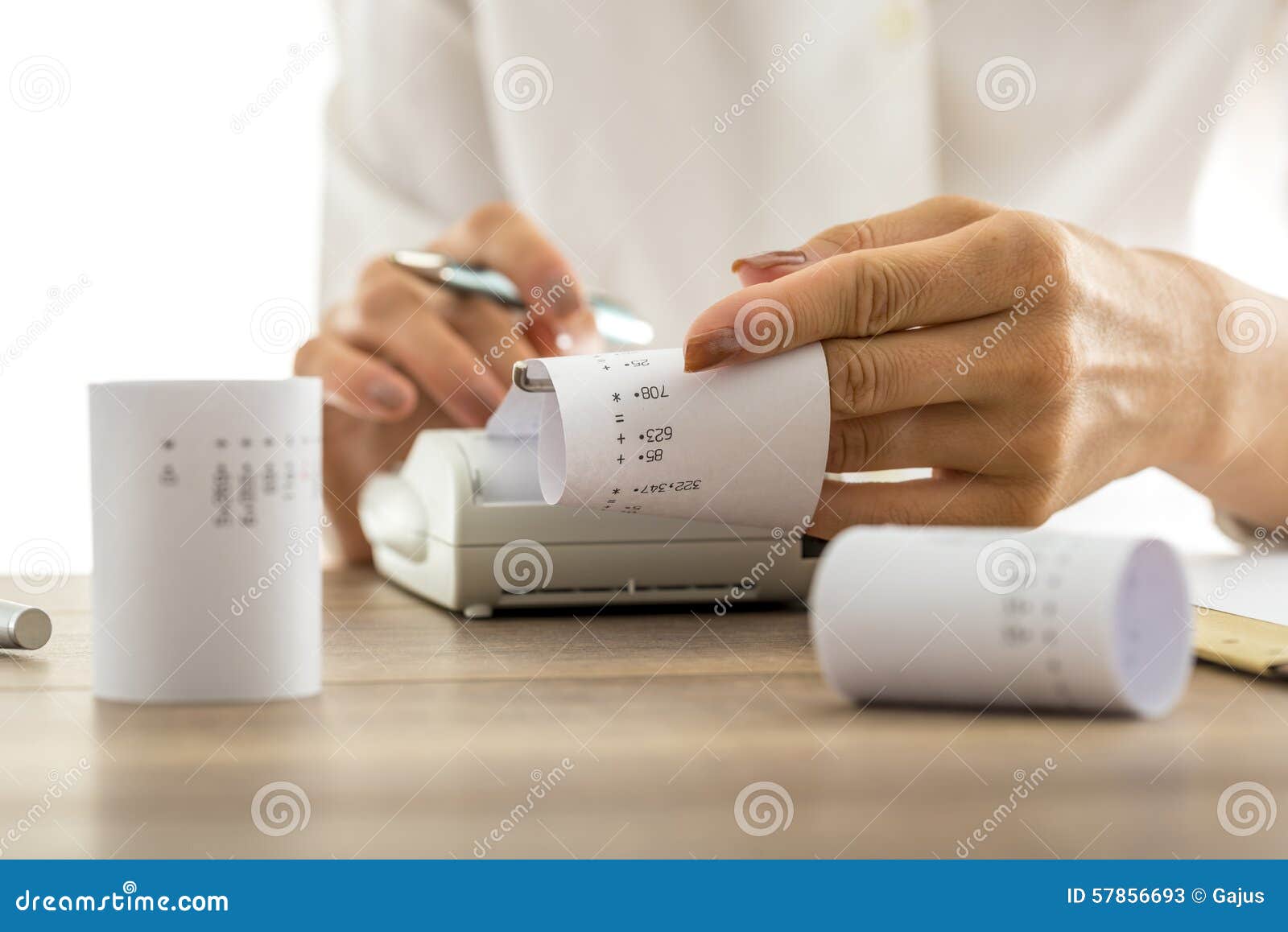 woman doing calculations on an adding machine